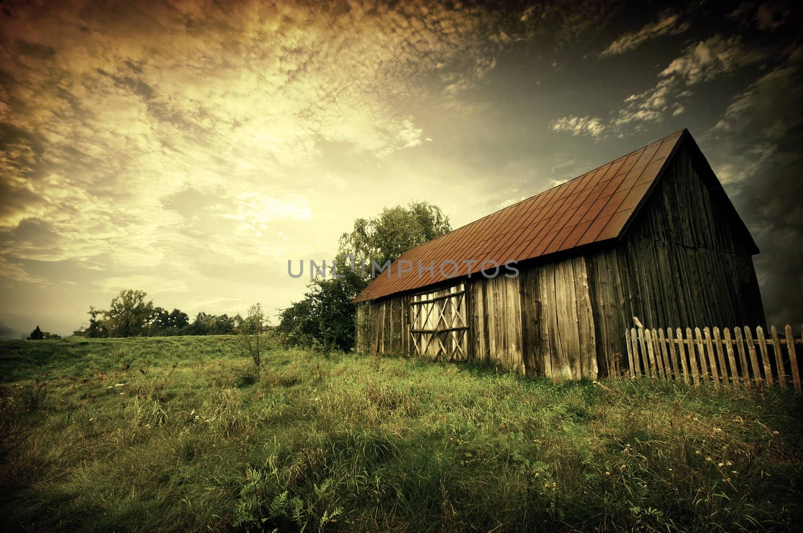 Old wooden bar with red roof over the dramatic sunset. Zalew Zegrzynski, Poland