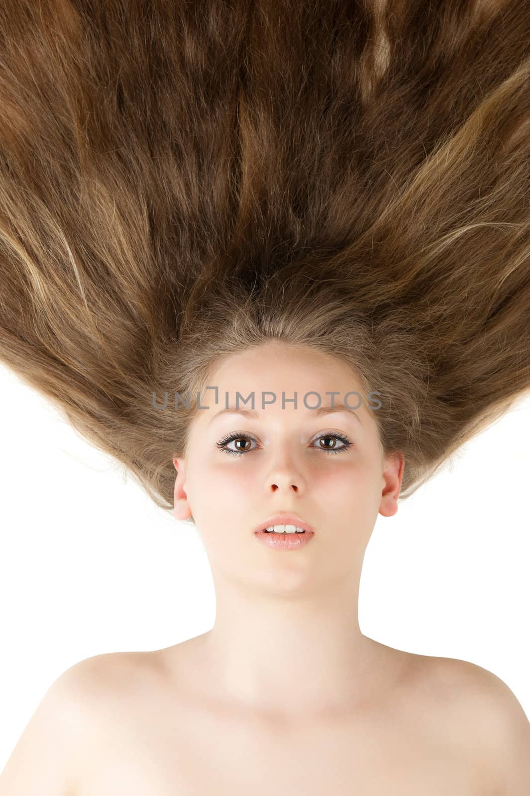 Healthy beautiful long hair closeup in motion created by wind. Isolated on white