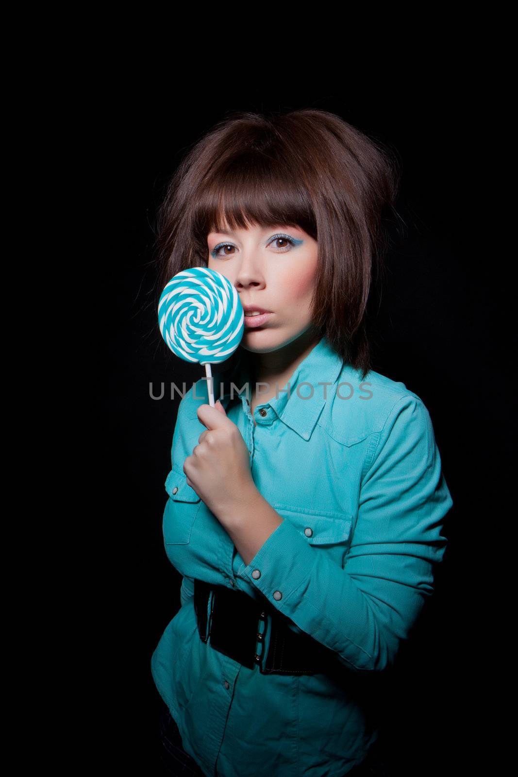 young woman with lolipop, black background