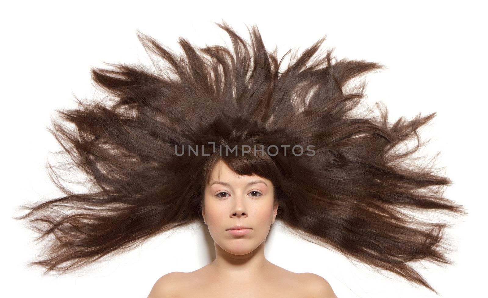 Woman with long hair straightened on the floor around the head