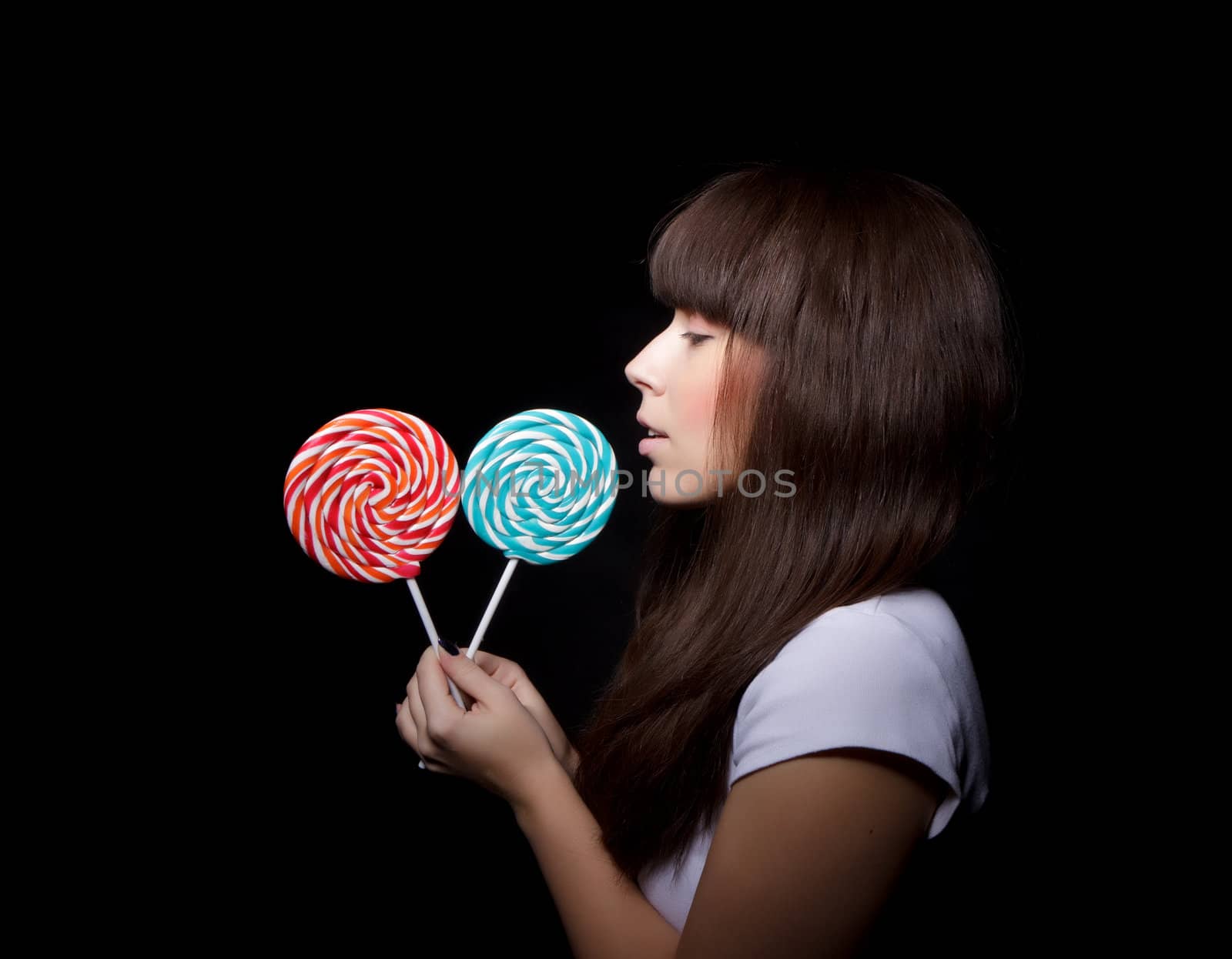 
young woman with lolipop, black background
