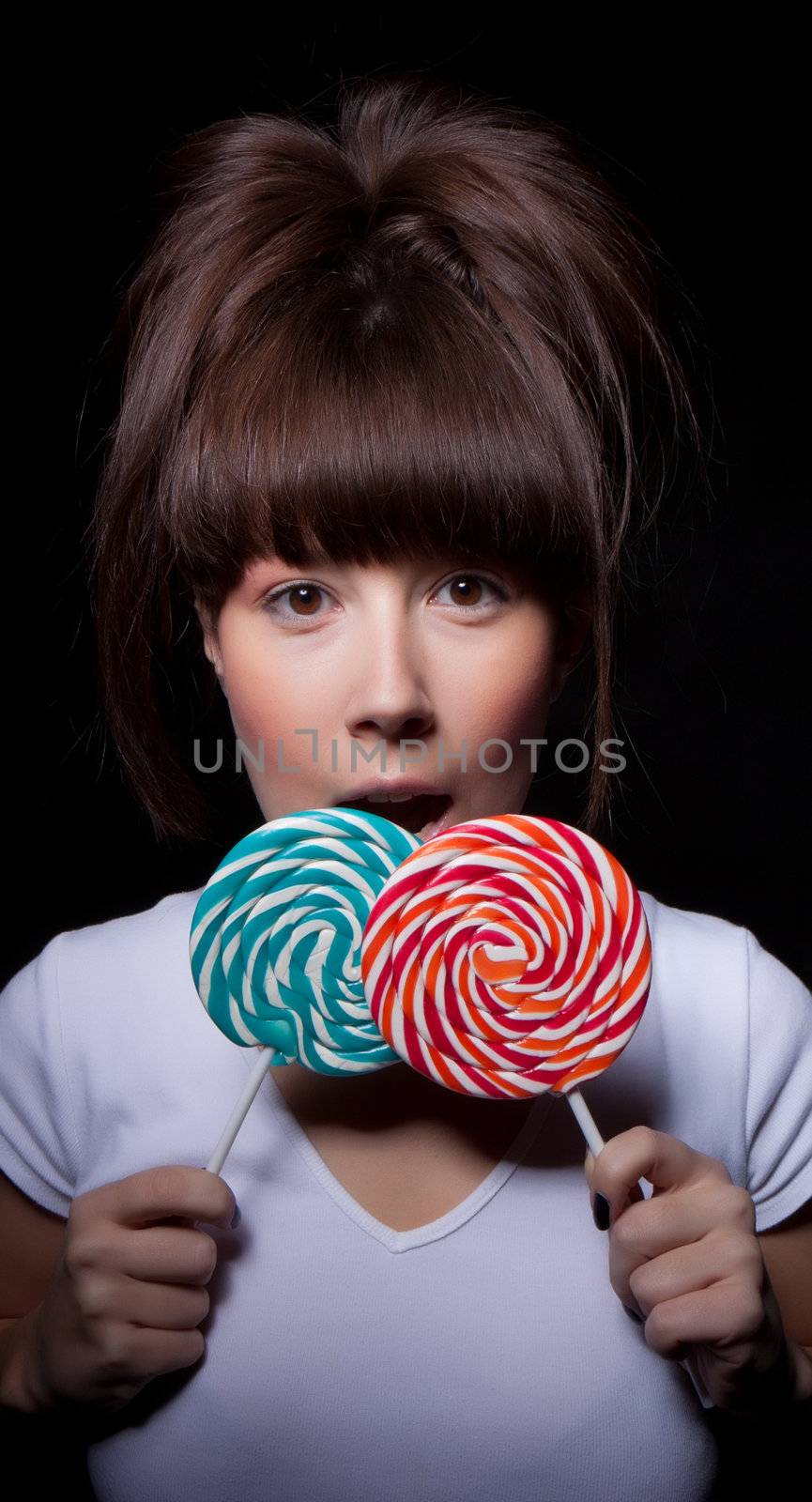 young woman with lolipop, black background