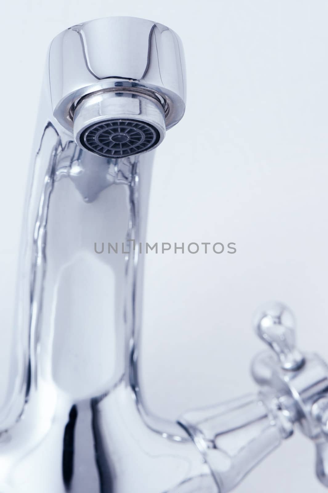 tap with drop water. Cold toned image. Closeup