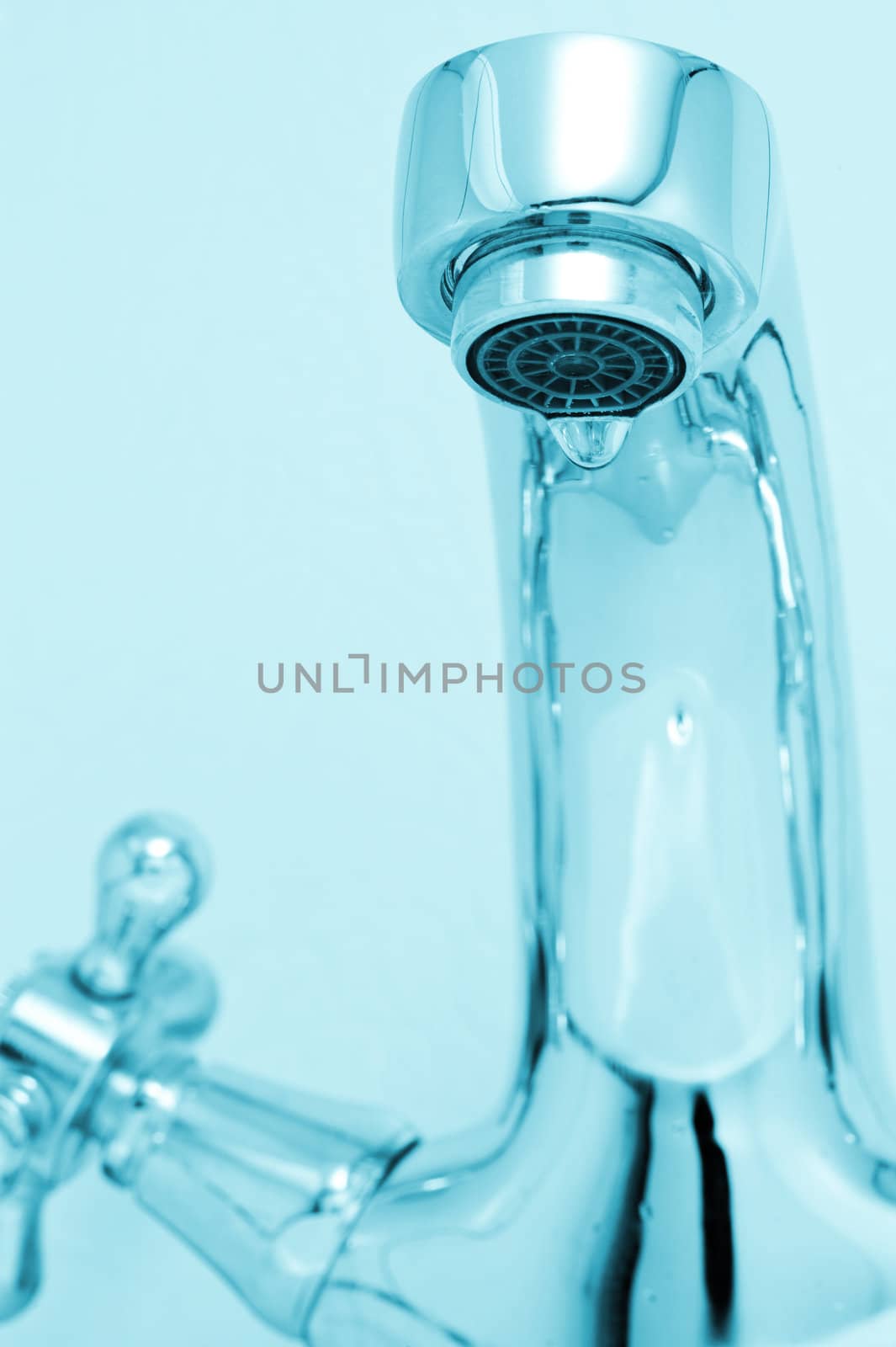 tap with drop water. Cold toned image. Closeup