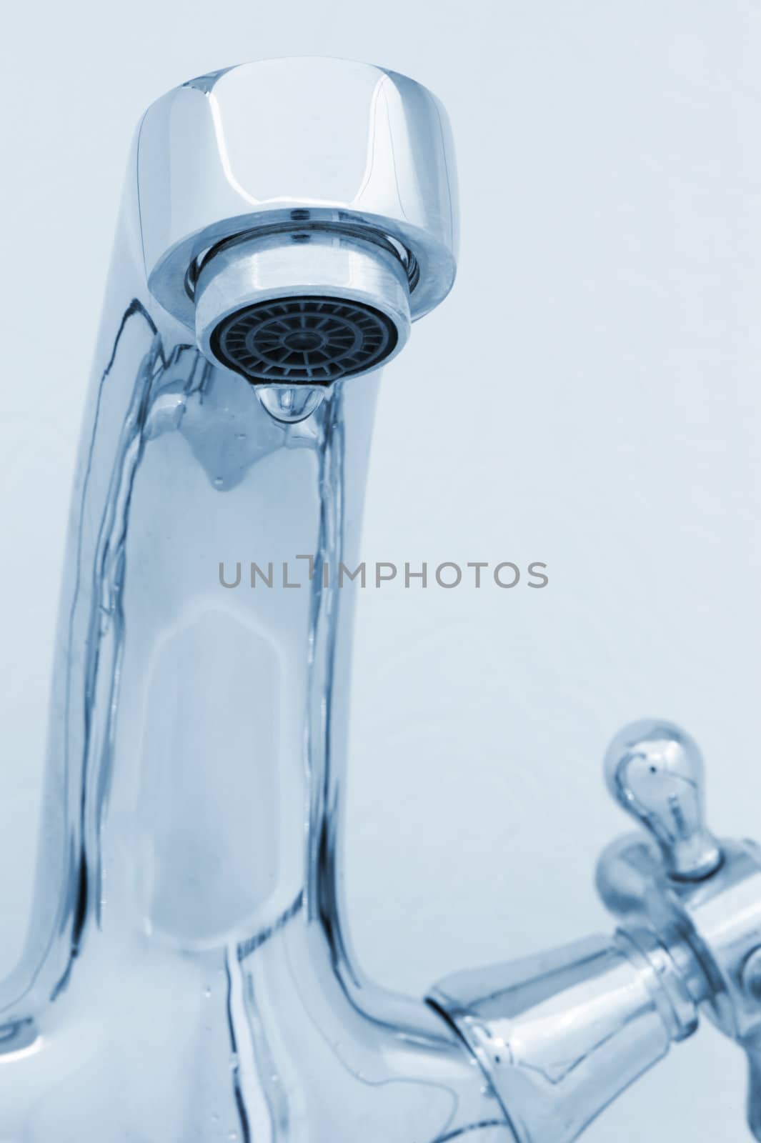 tap with drop water. Cold toned image. Closeup
