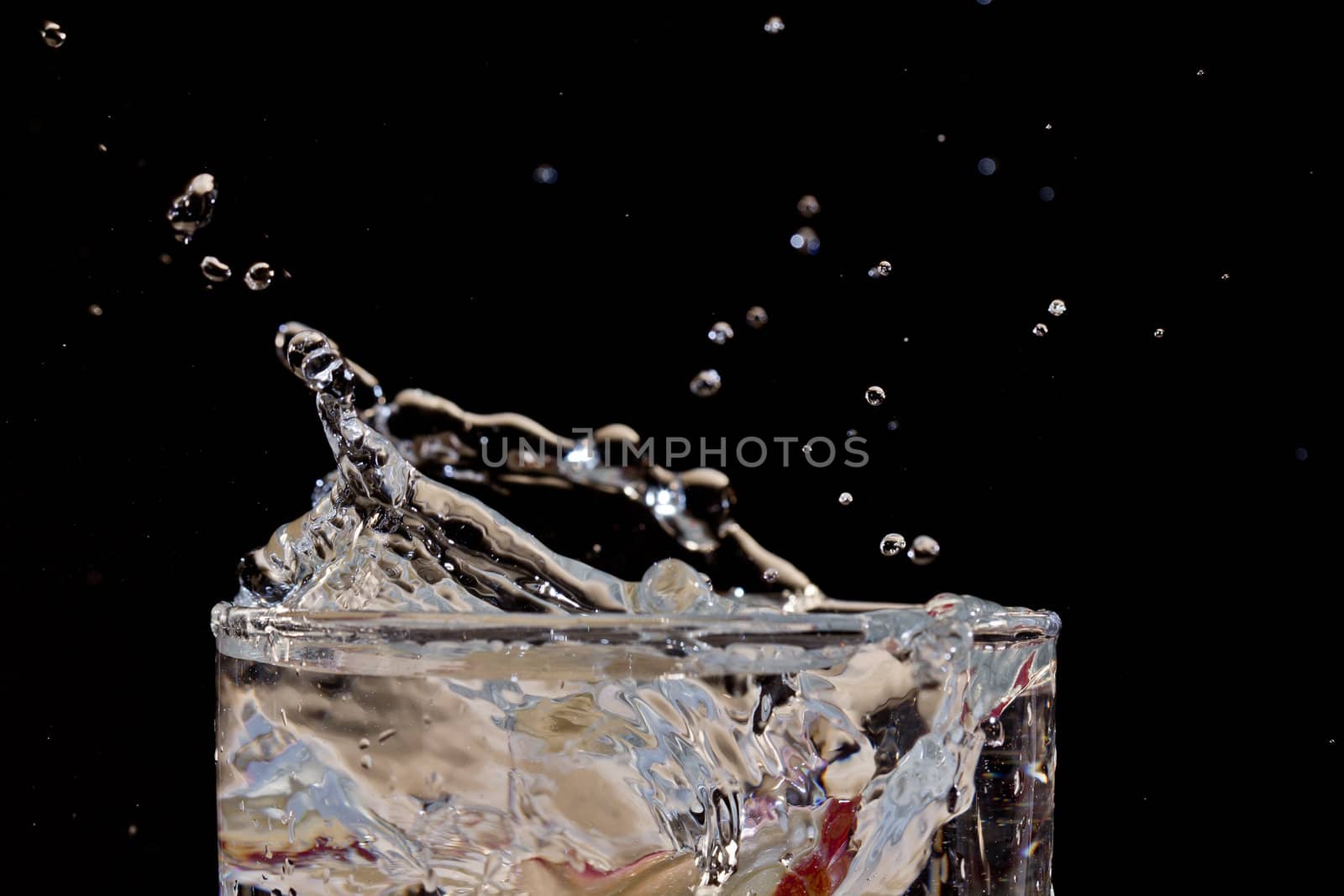 The motion of a slice of apple splashing into a glass of water