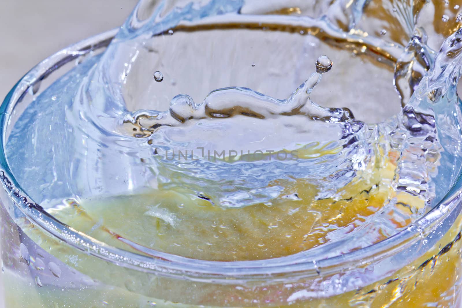 The motion of a slice of apple splashing into a glass of water