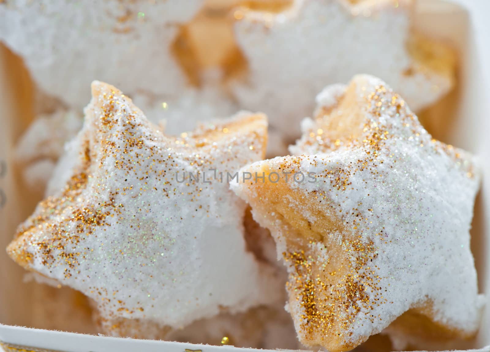 Christmas cookies in a box with gold stars