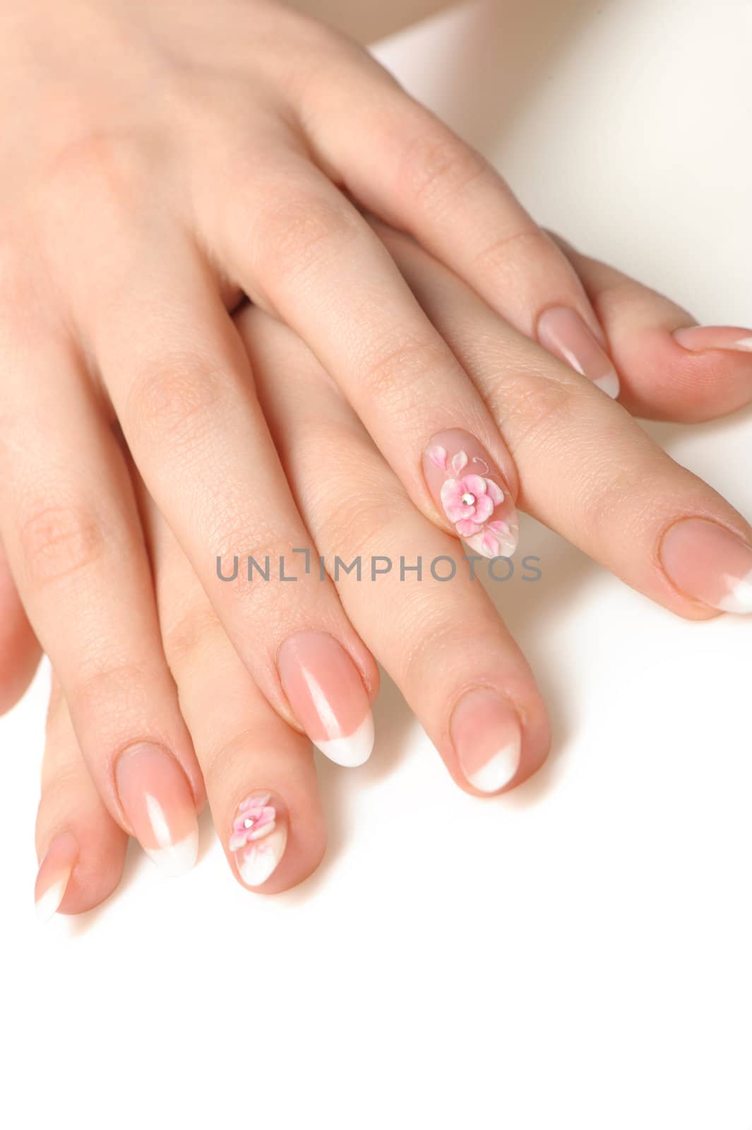 Manicure isolated on white. Well-groomed female hands with a decorative element - a flower
