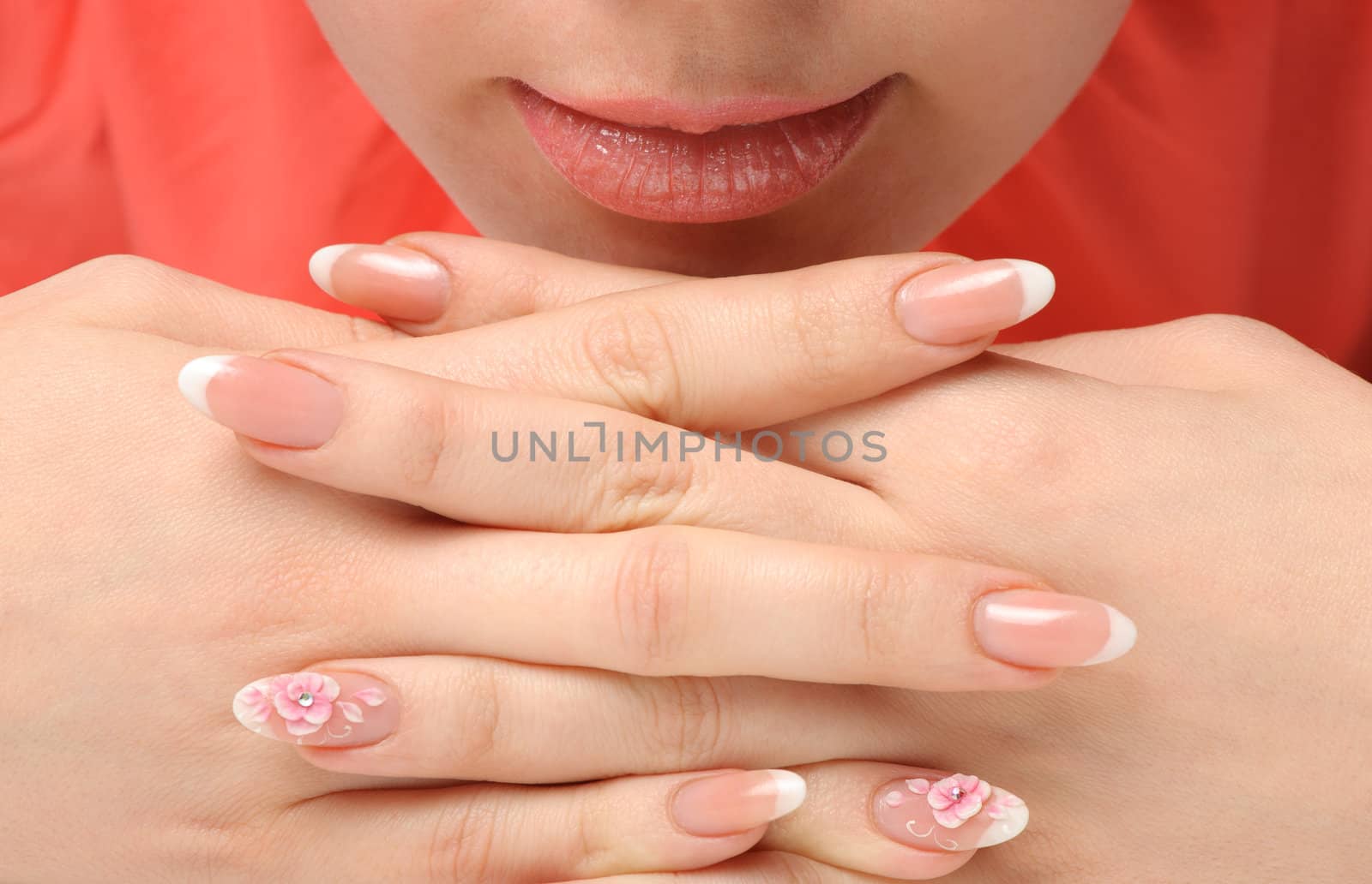 Manicure. Well-groomed female hands with a decorative element - a flower