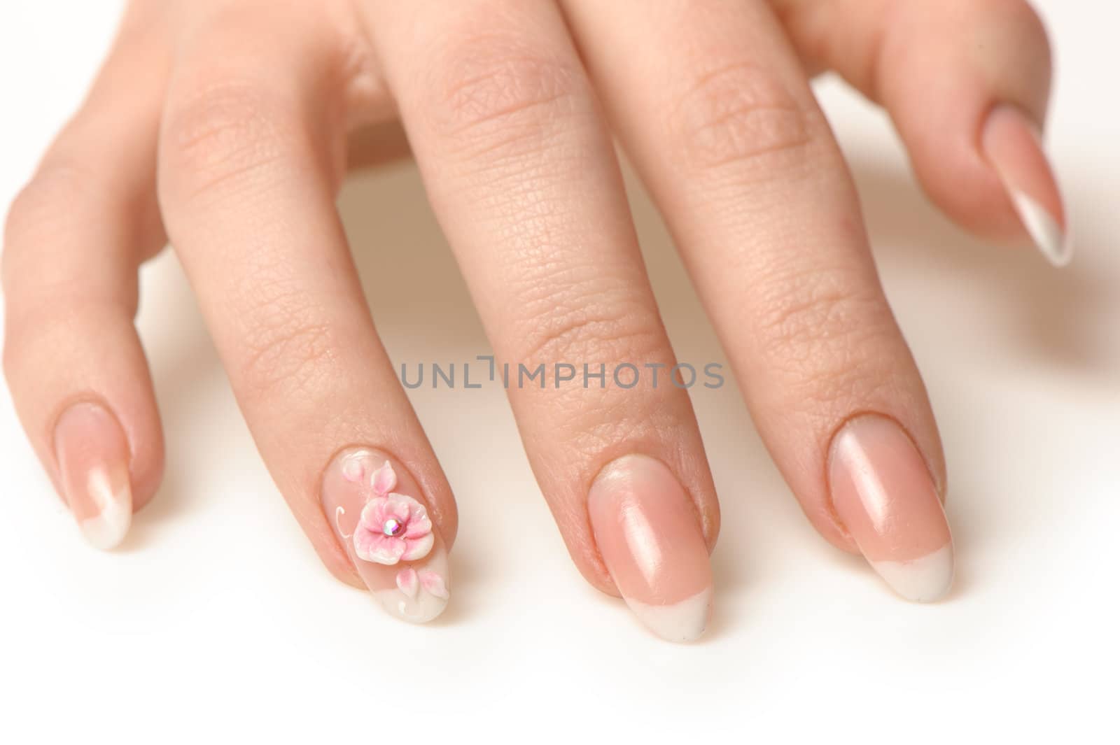 Manicure isolated on white. Well-groomed female hands with a decorative element - a flower