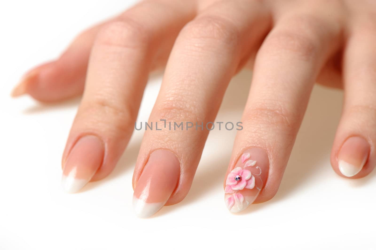 Manicure isolated on white. Well-groomed female hands with a decorative element - a flower