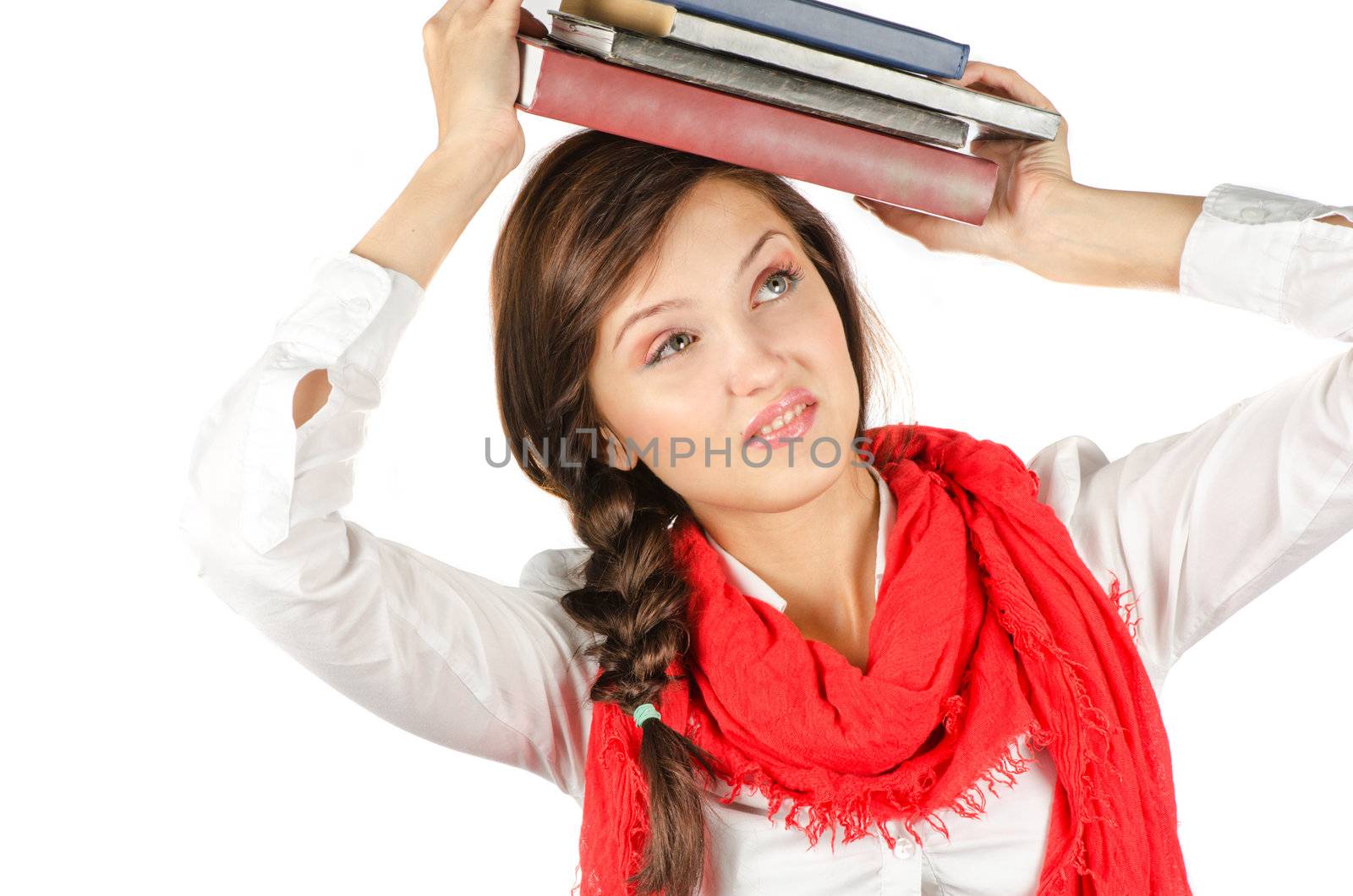 Young student girl with her books in hand at head, smiling and looking at the camera