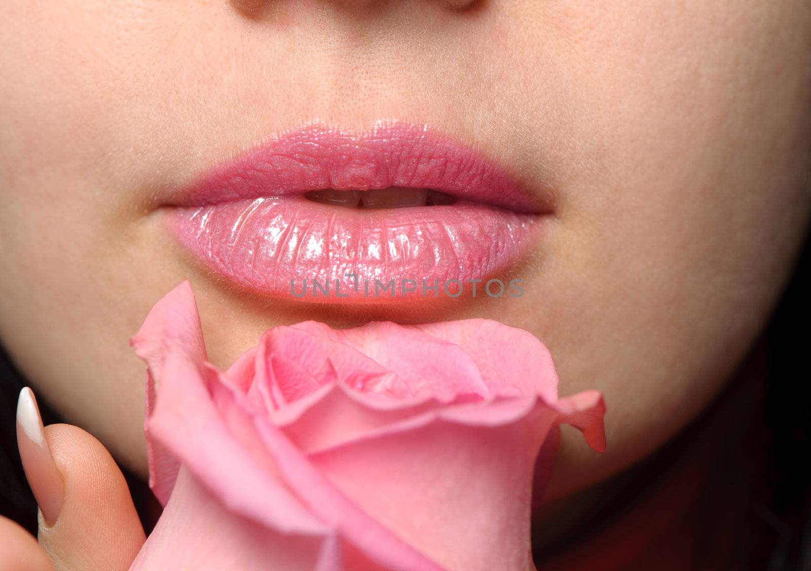The woman with a rose. A photo close up parts of the person and a flower