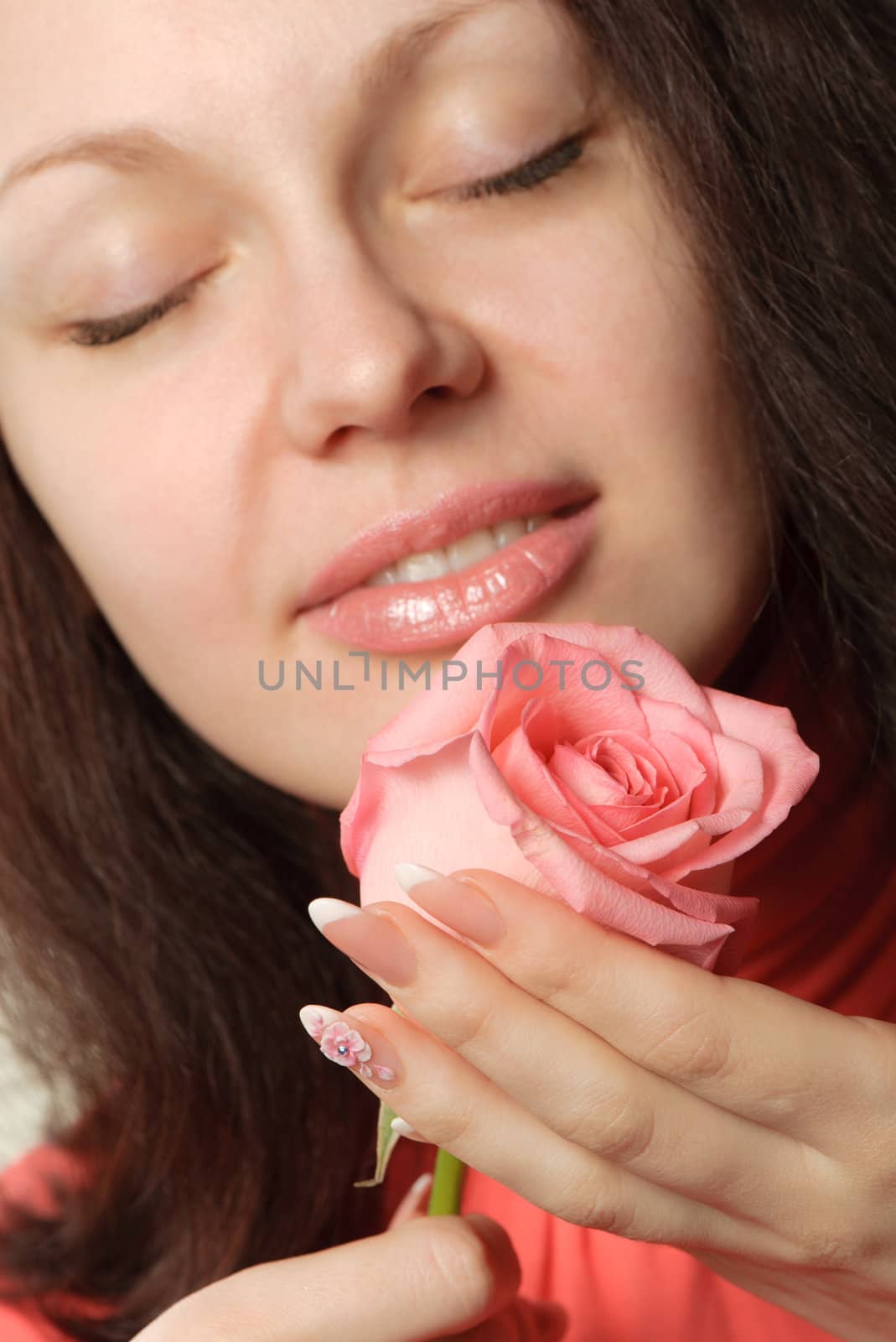 The woman with a rose. A photo close up parts of the person and a flower