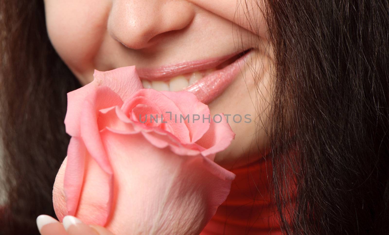 The woman with a rose. A photo close up parts of the person and a flower