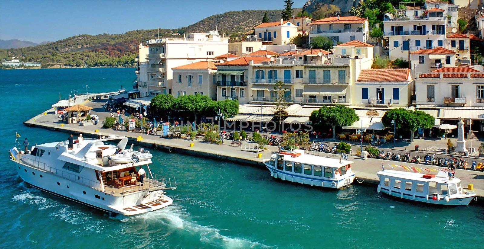 Yacht is doubling town quay in Greek island