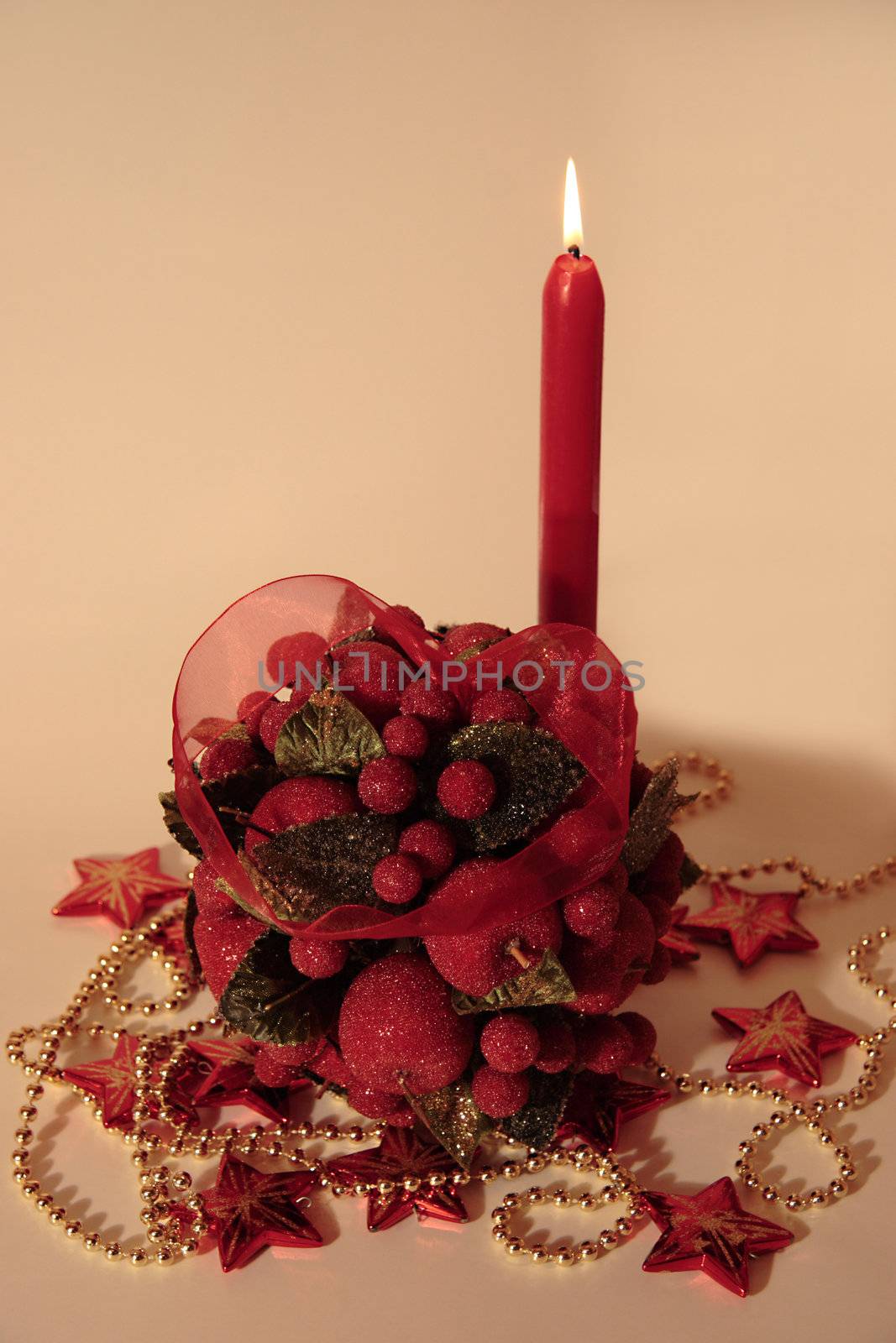 kissing ball against a decorated background with candles