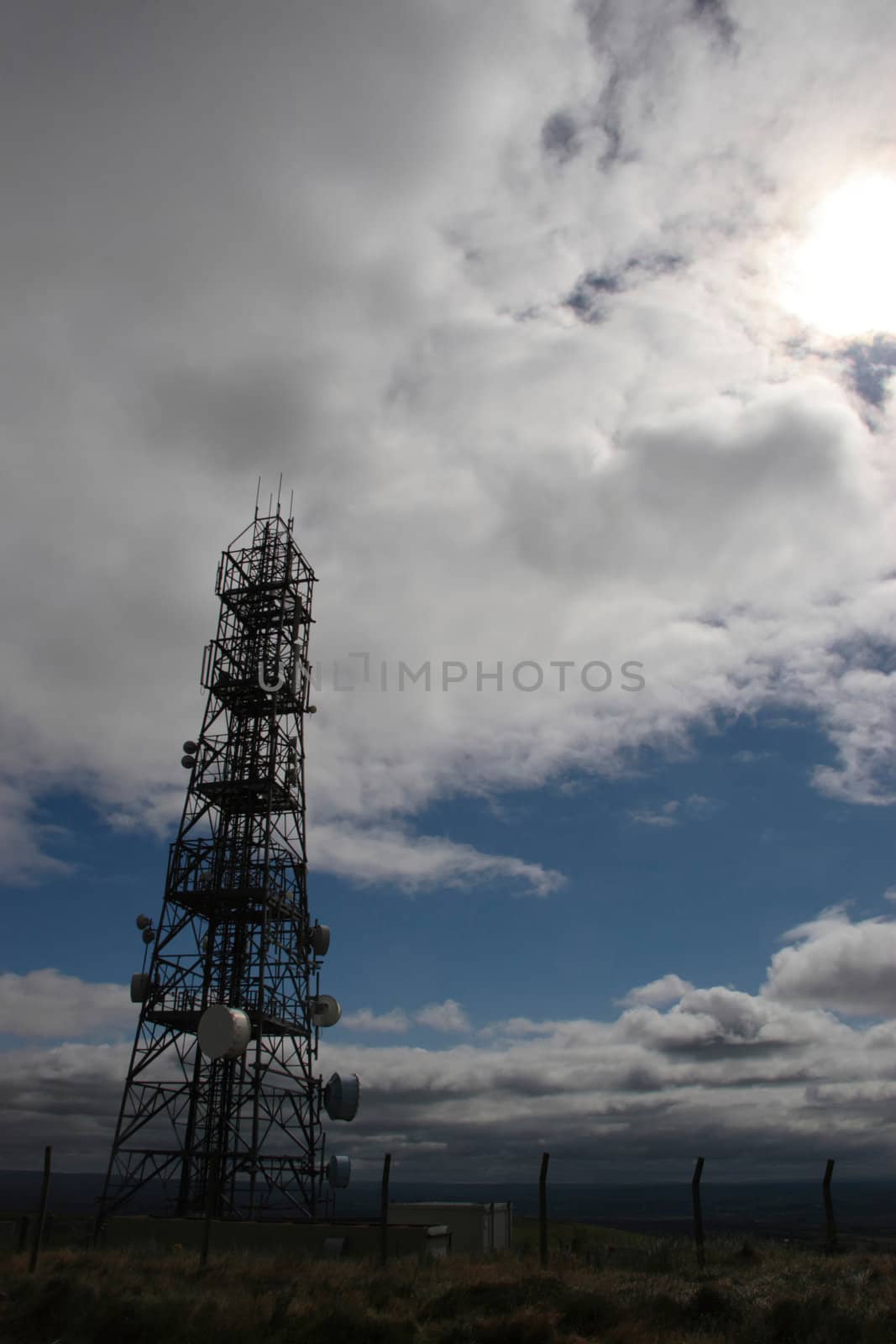 communication masts and dishes on top of a hill