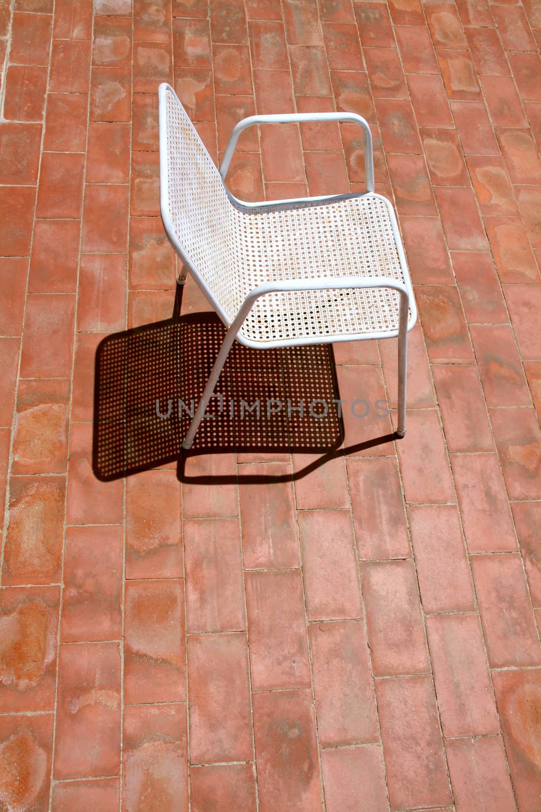 a chair waiting for a relaxing sunbath, alone on the terrace