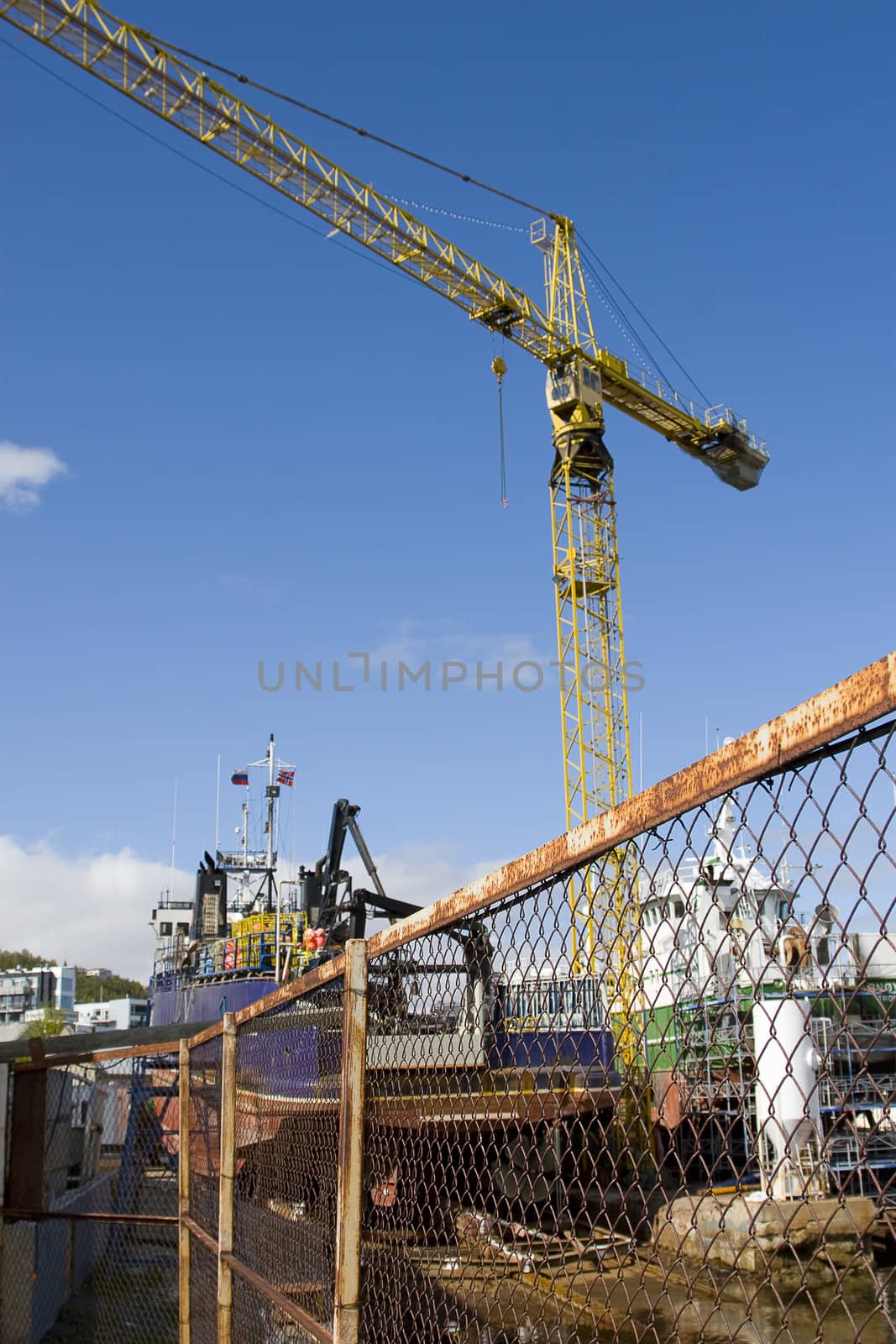 A boat under repair, area closed by a fence. Good illustration for industry, boat, production, fishing, locked off etc.