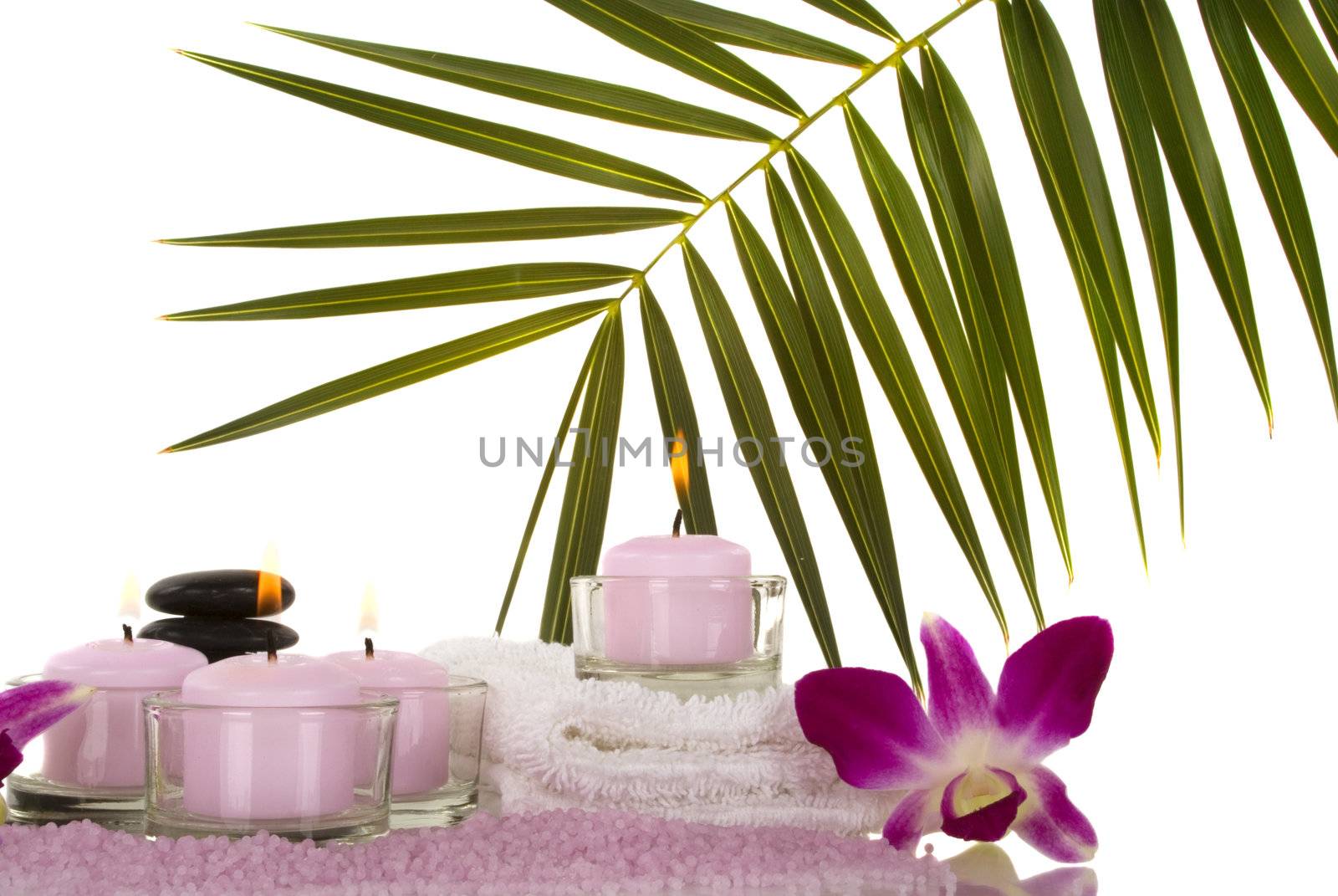 Orchids, towel, candles, pebbles and aromatic bath salt in a spa