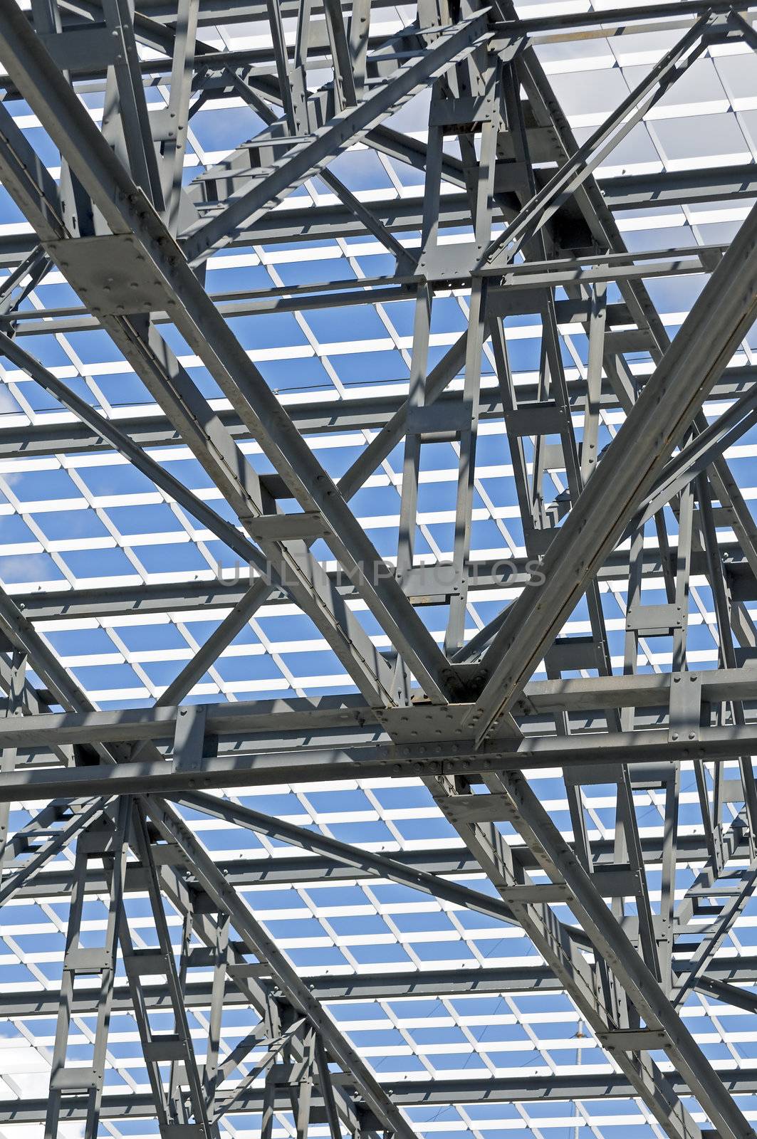 Detail of steel framework of a roof against a blue sky