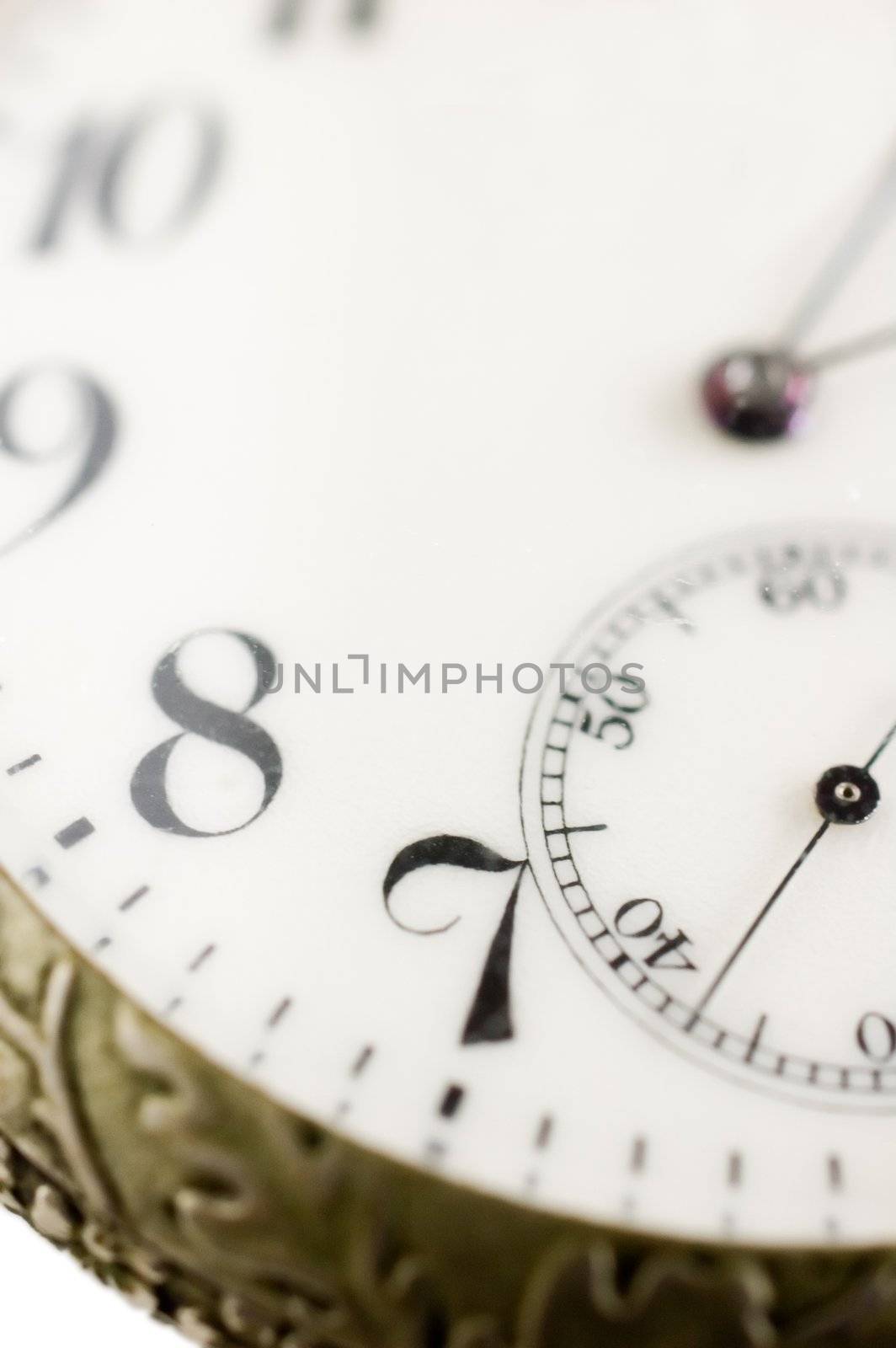 Macro shot of an old pocket watch with selective focus on number seven