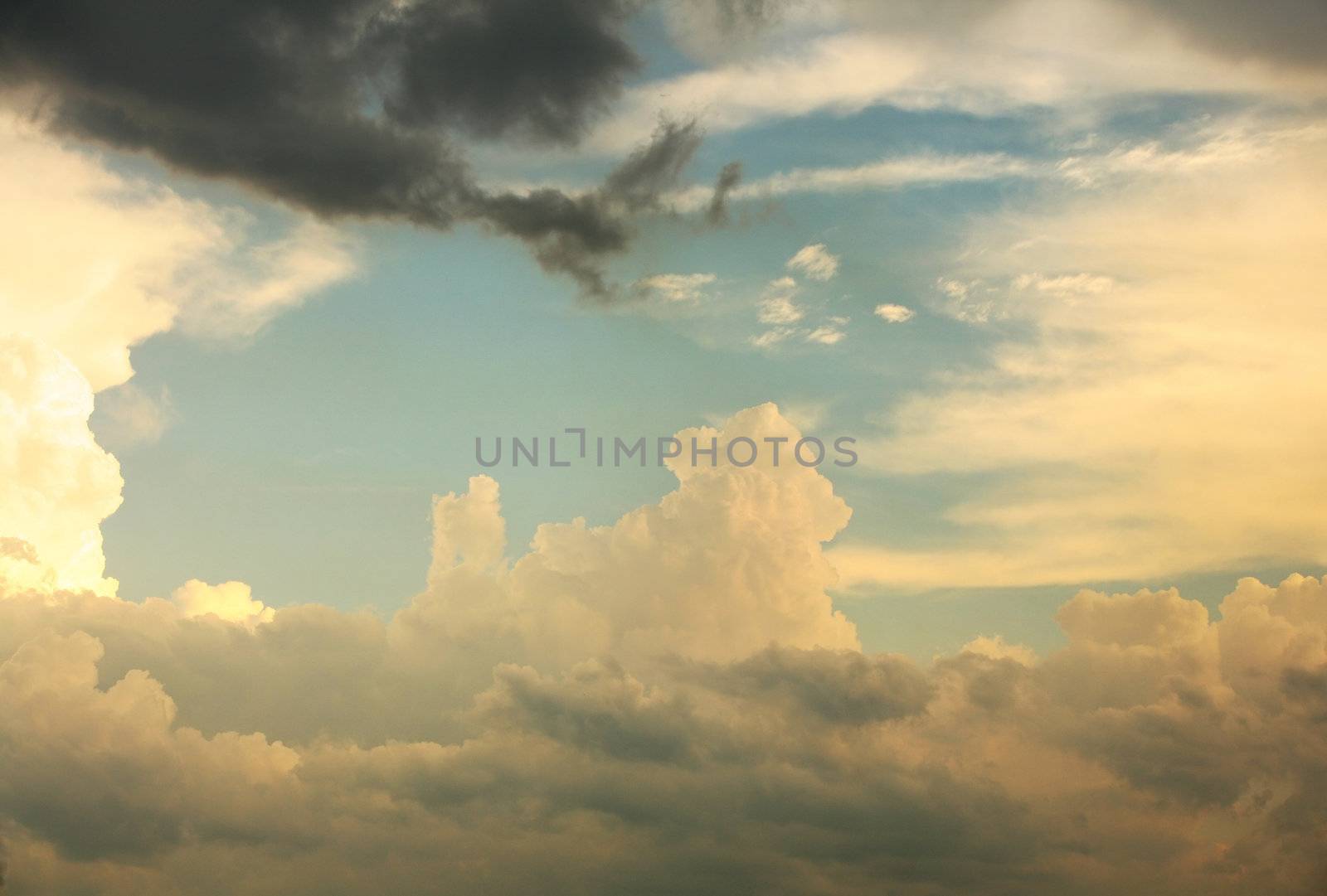 Different clouds before a thunder-storm covered by the sun