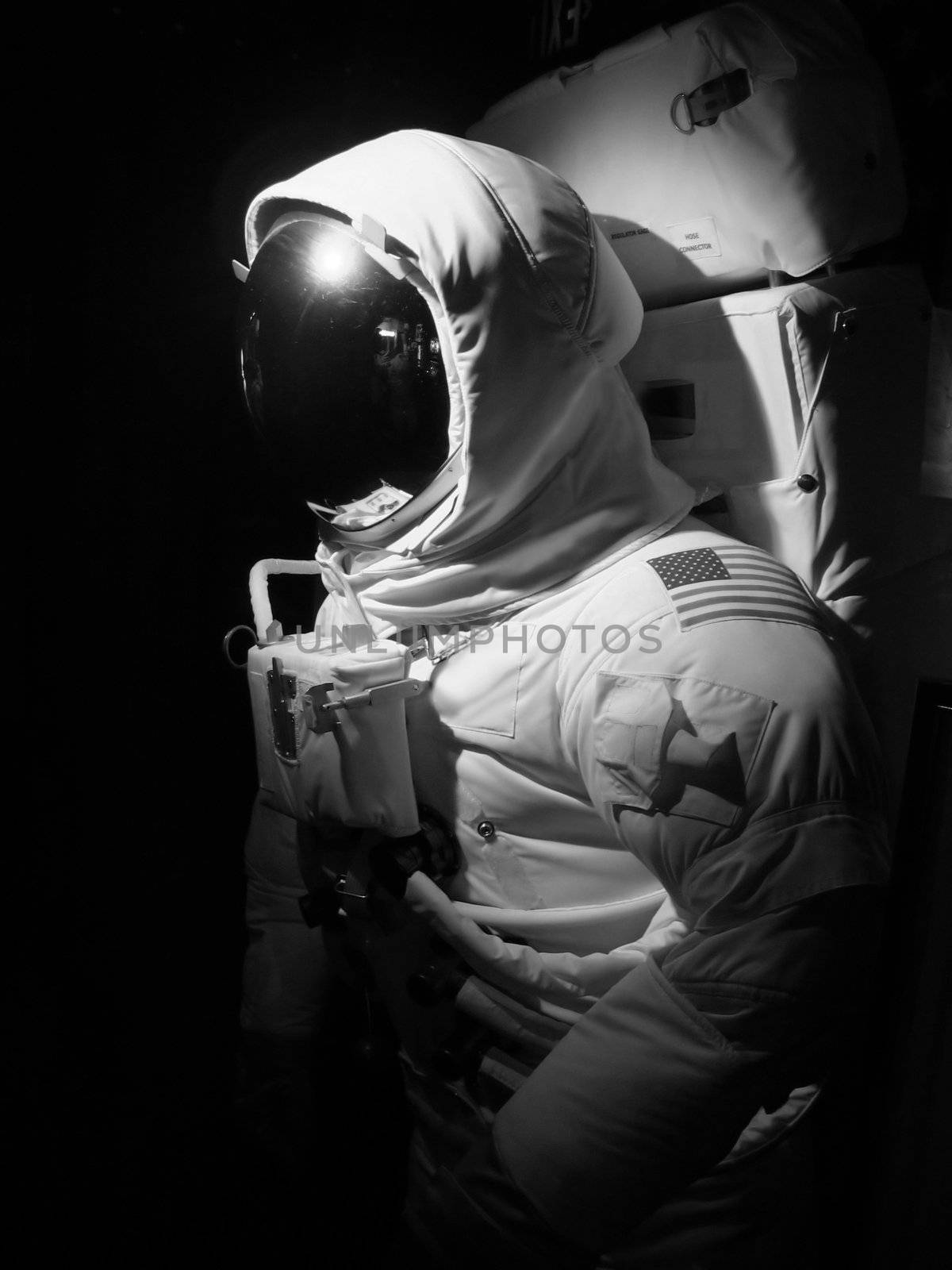 An astronaut set up under dramatic lighting - black and white.  