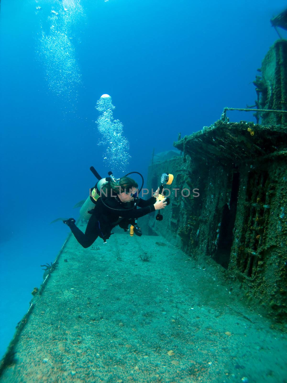 Underwater Photographer shooting a Sunken Ship in Cayman  Brac