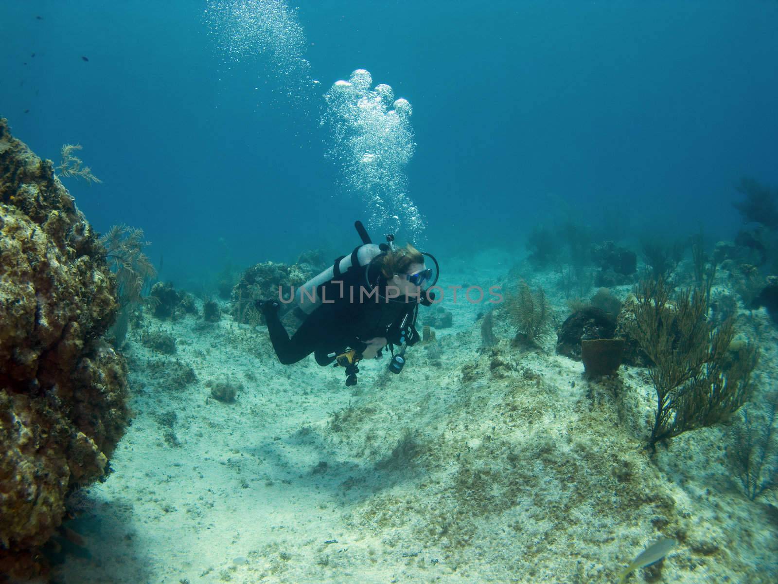 Woman Scuba Diver swimming over a Cayman Island Reef