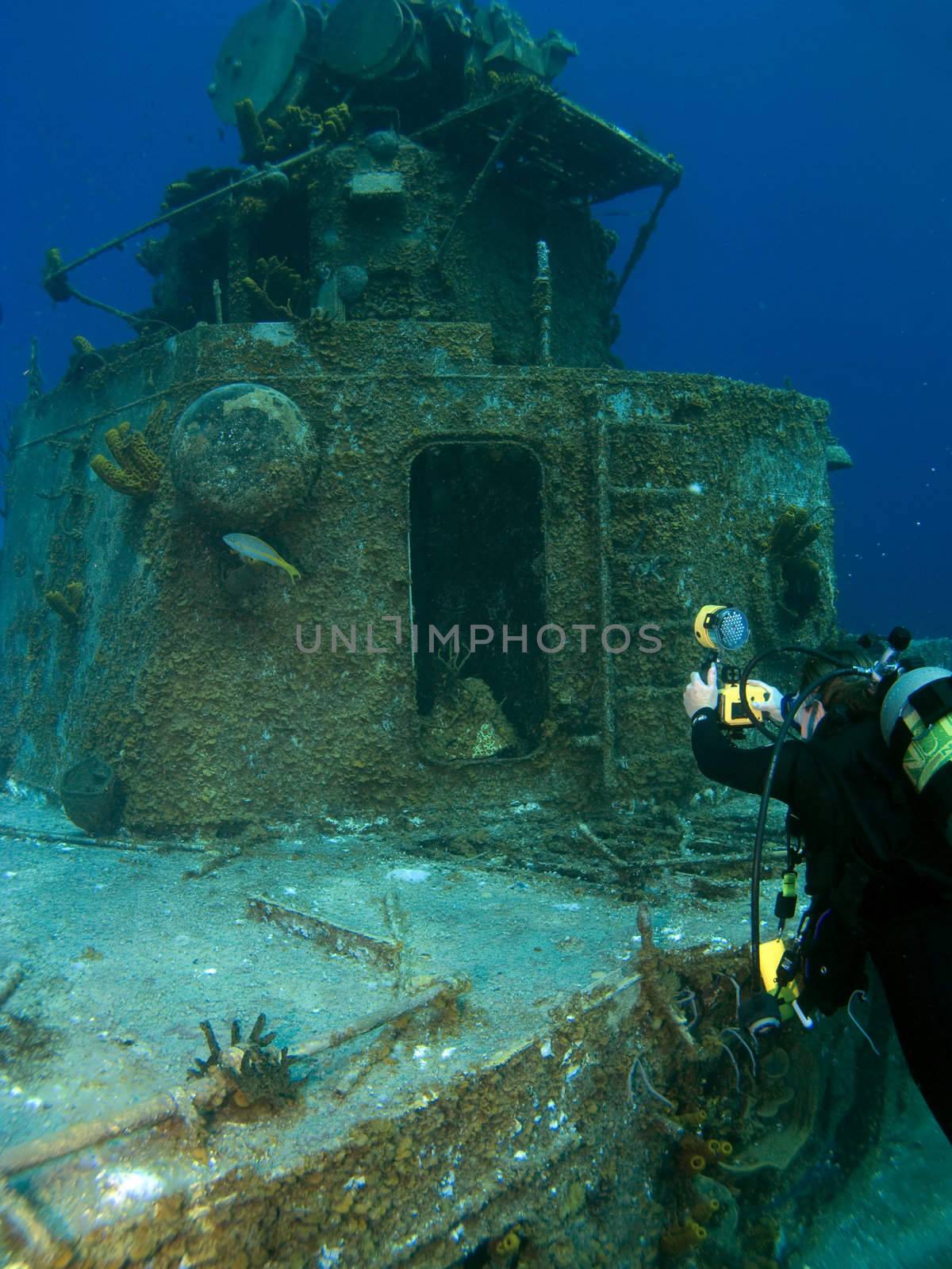 Underwater Photographer shooting the Radar Tower on a Sunken Destroyer