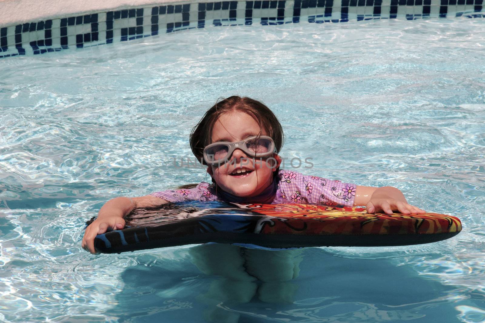 girl having fun just floating in a pool