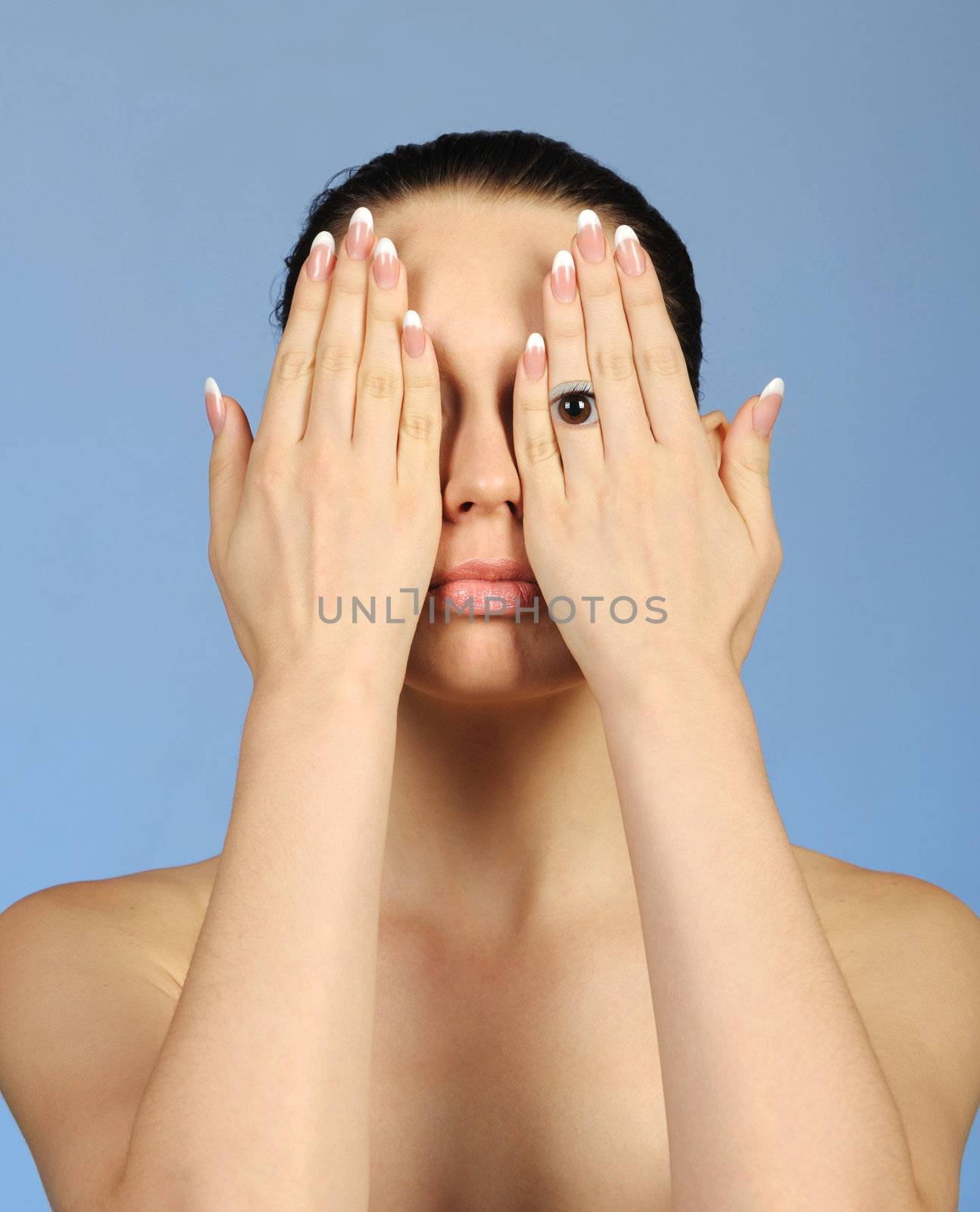 The abstract image of the girl look through fingers. A blue background