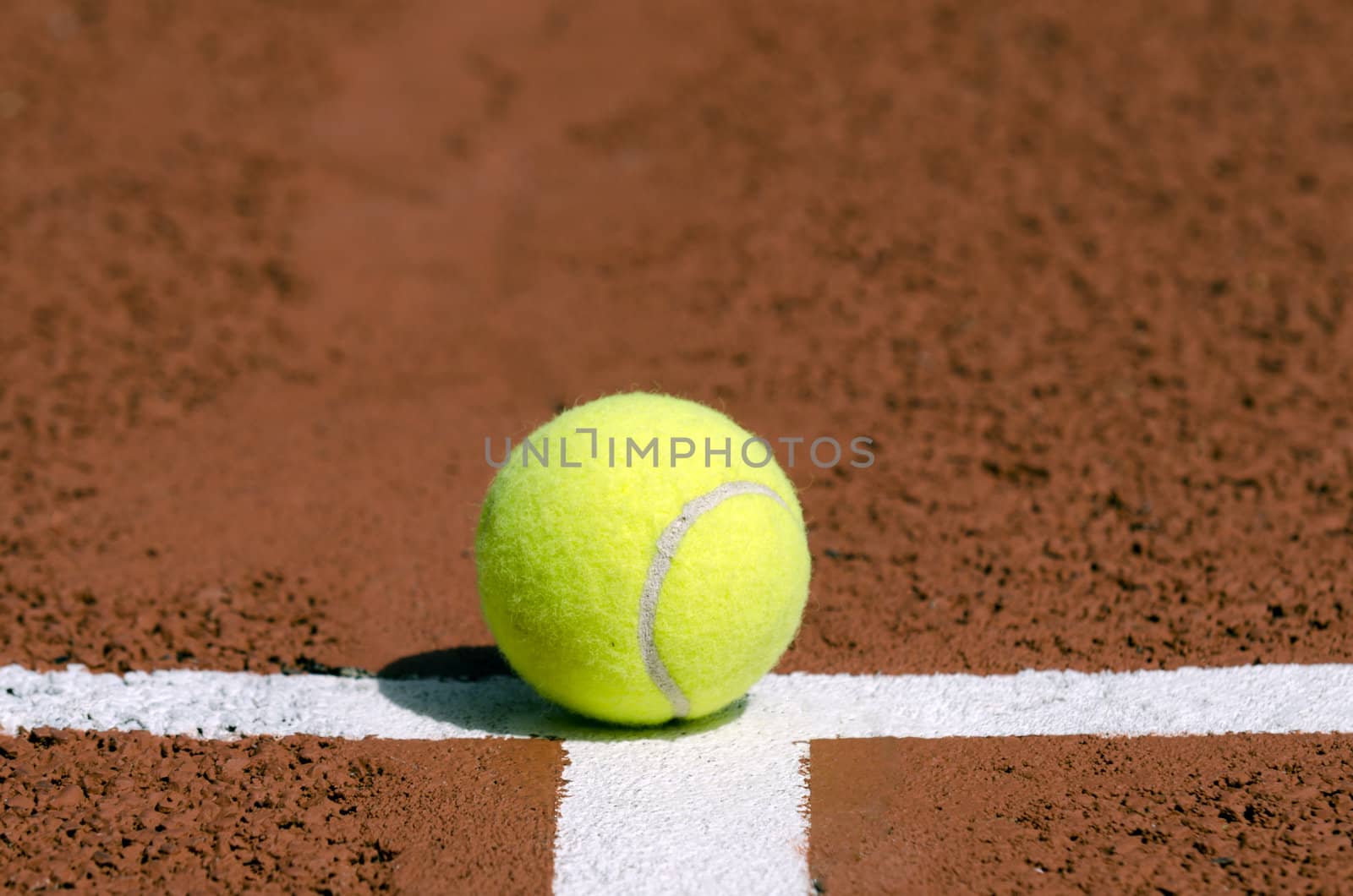 a tennis ball on the white line