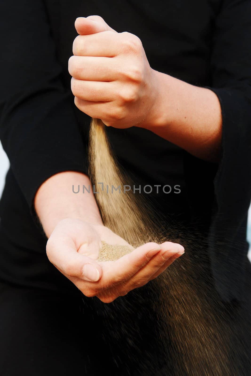 sand running through hands as a symbol for time running, lost etc.............