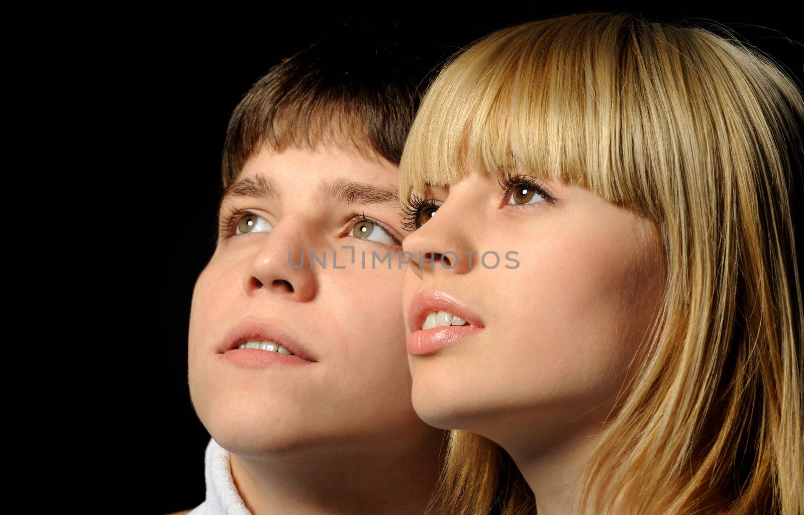 Young enamoured pair. A romantic atmosphere. A dark back