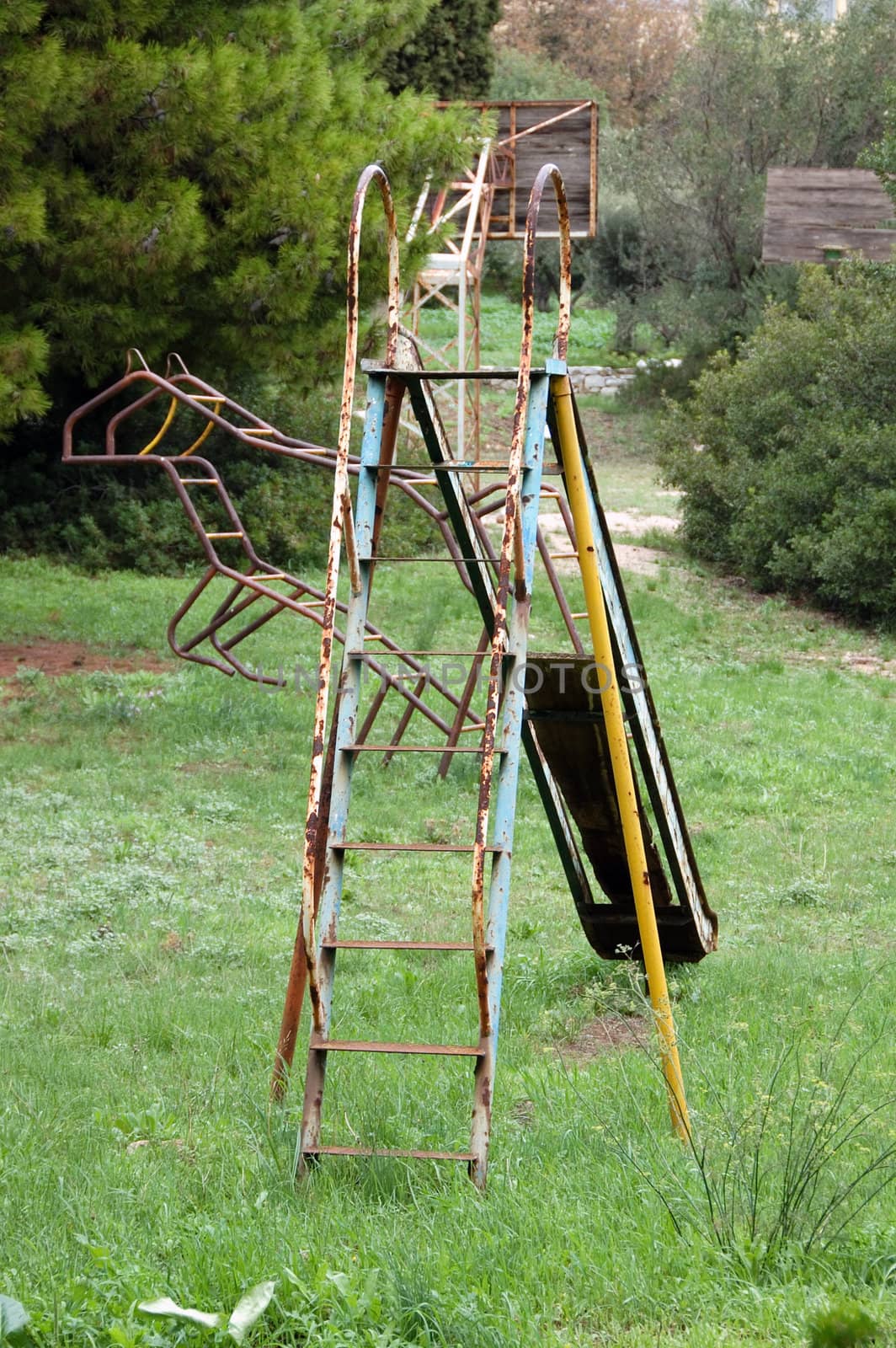 Vintage rusty slide at an abandoned playground.