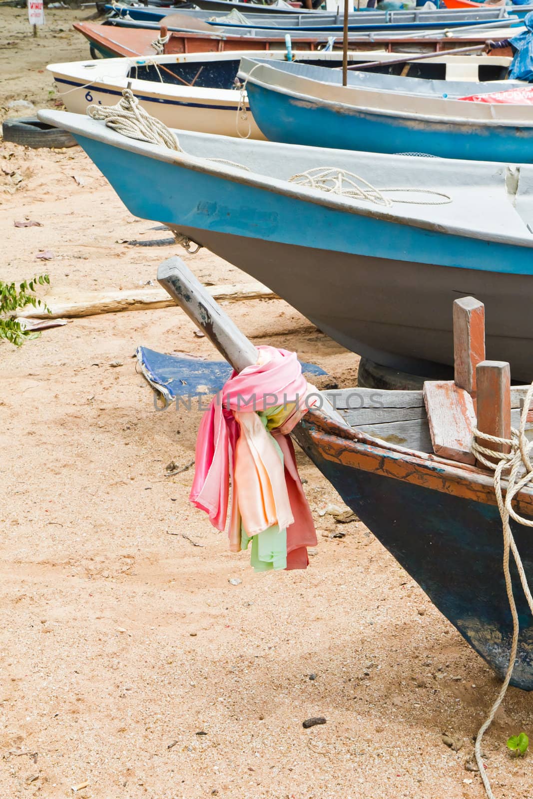 Fishing Boats on the beach near the ocean in view.