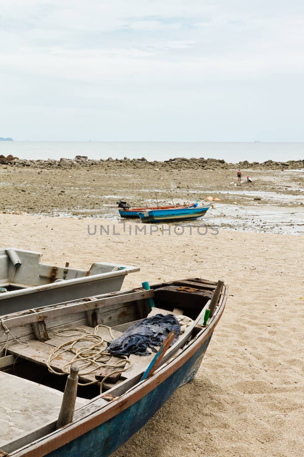 Fishing Boats on the beach near the ocean in view.