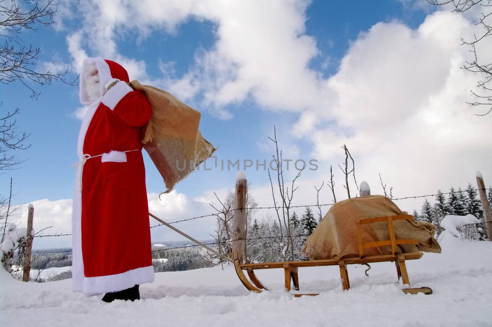 Santa Claus, Father Christmas in a beautiful winter landscape