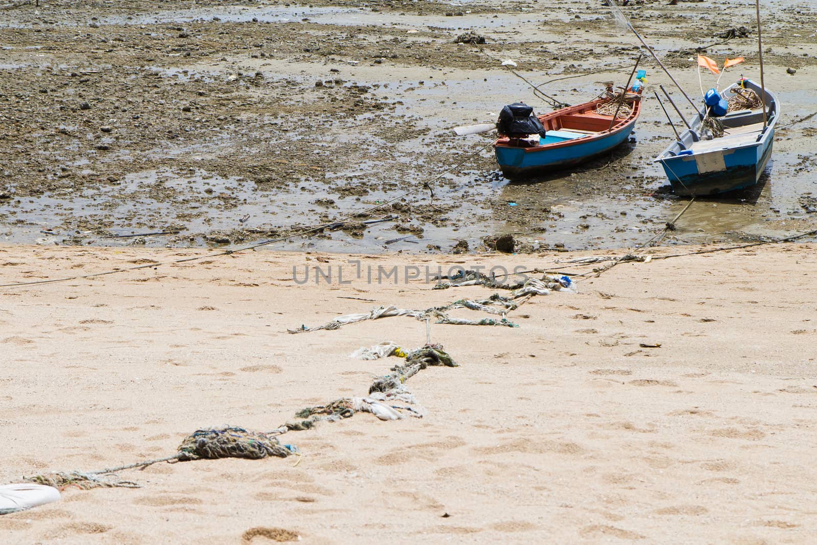 Rope tied to a fishing boat on the beach. by Na8011seeiN