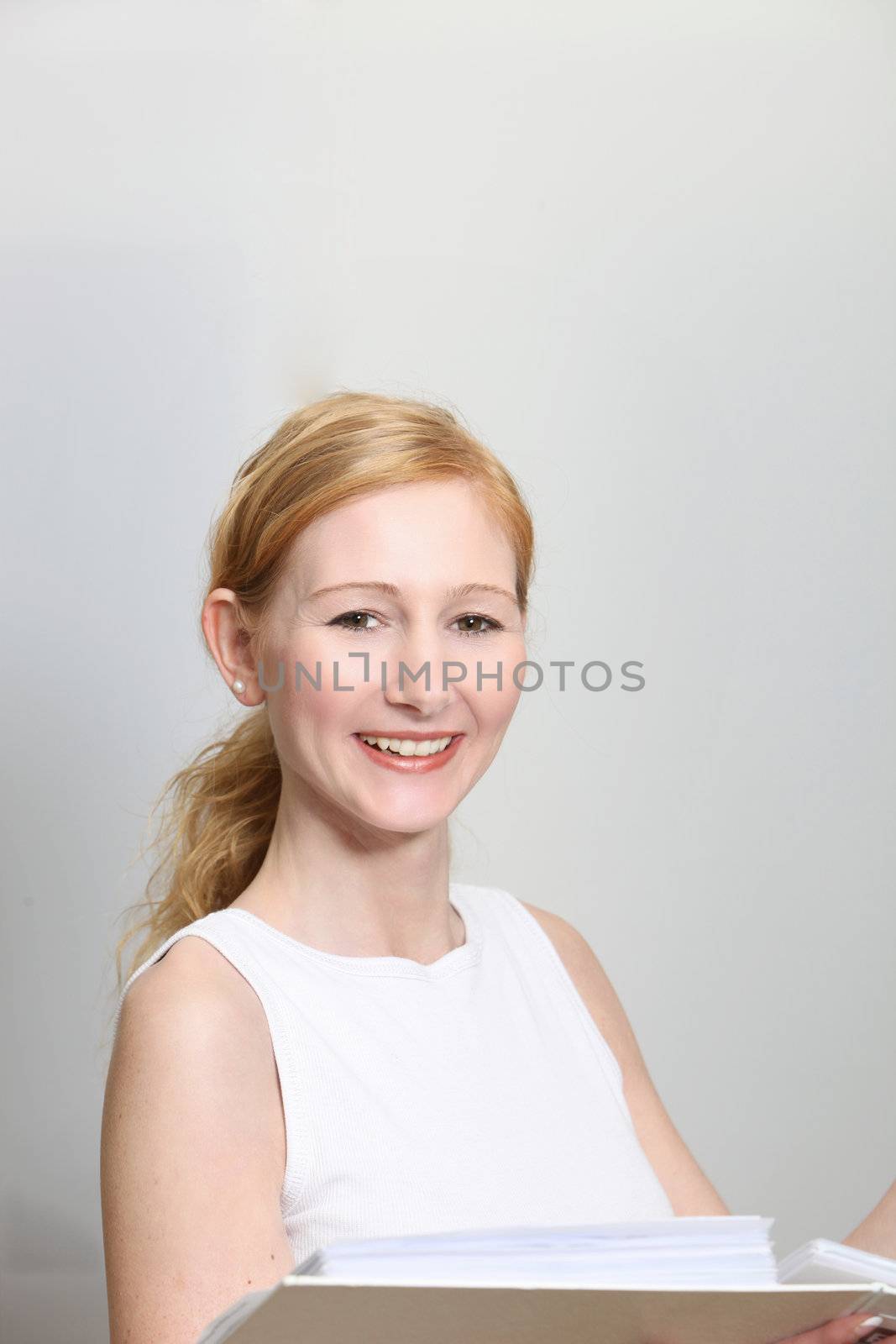 Pretty Woman in office with documents in her hands - portrait format