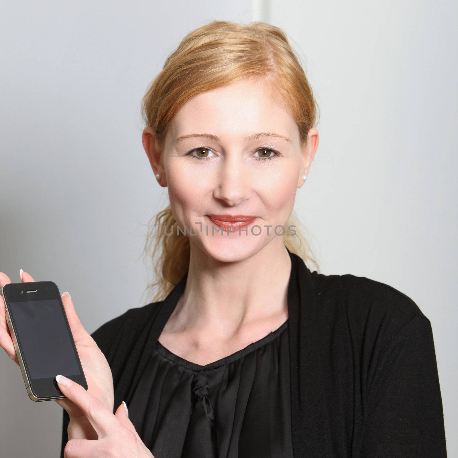 Young, smiling woman presented their smartphone - square

