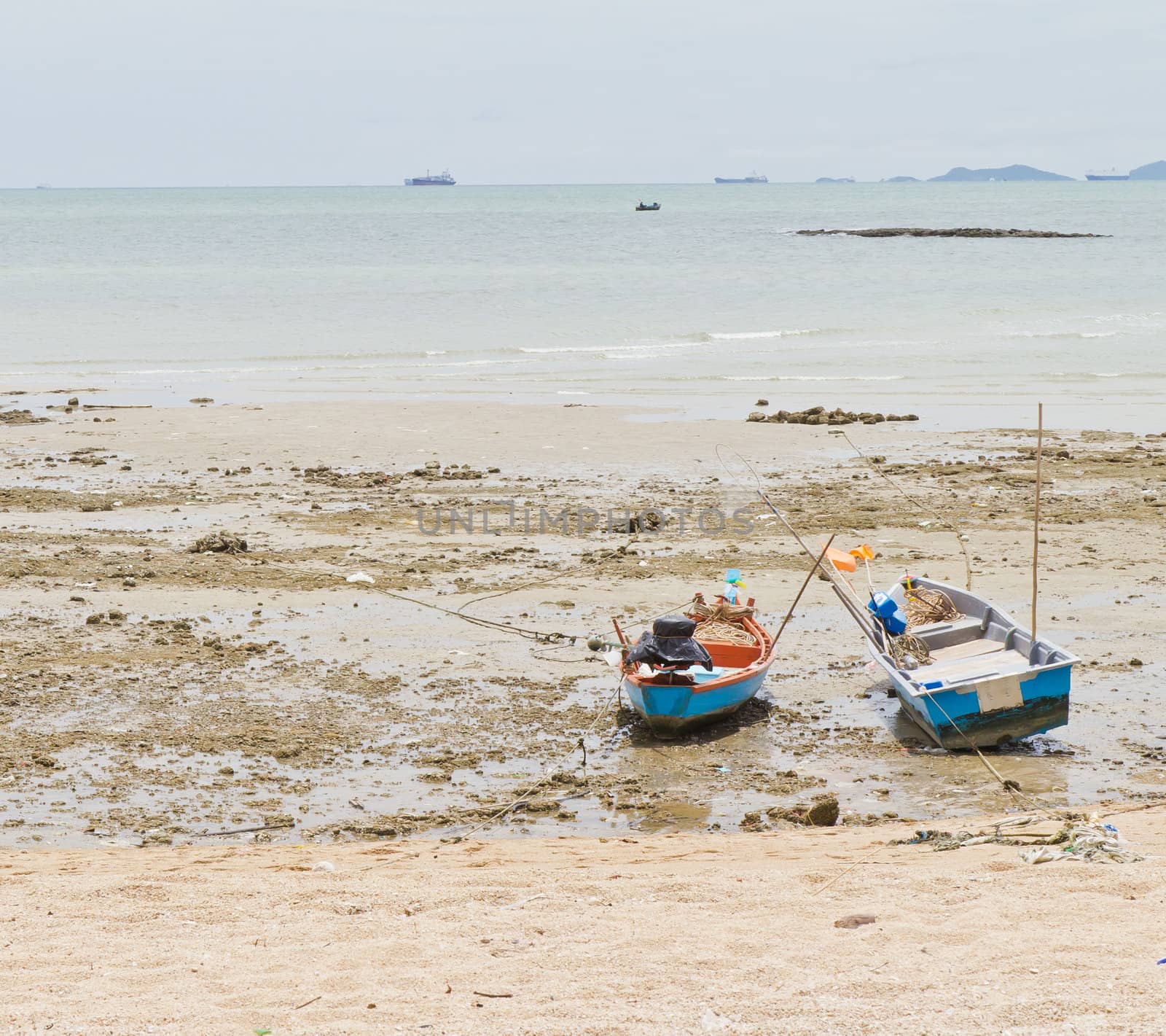 Rope tied to a fishing boat on the beach. by Na8011seeiN