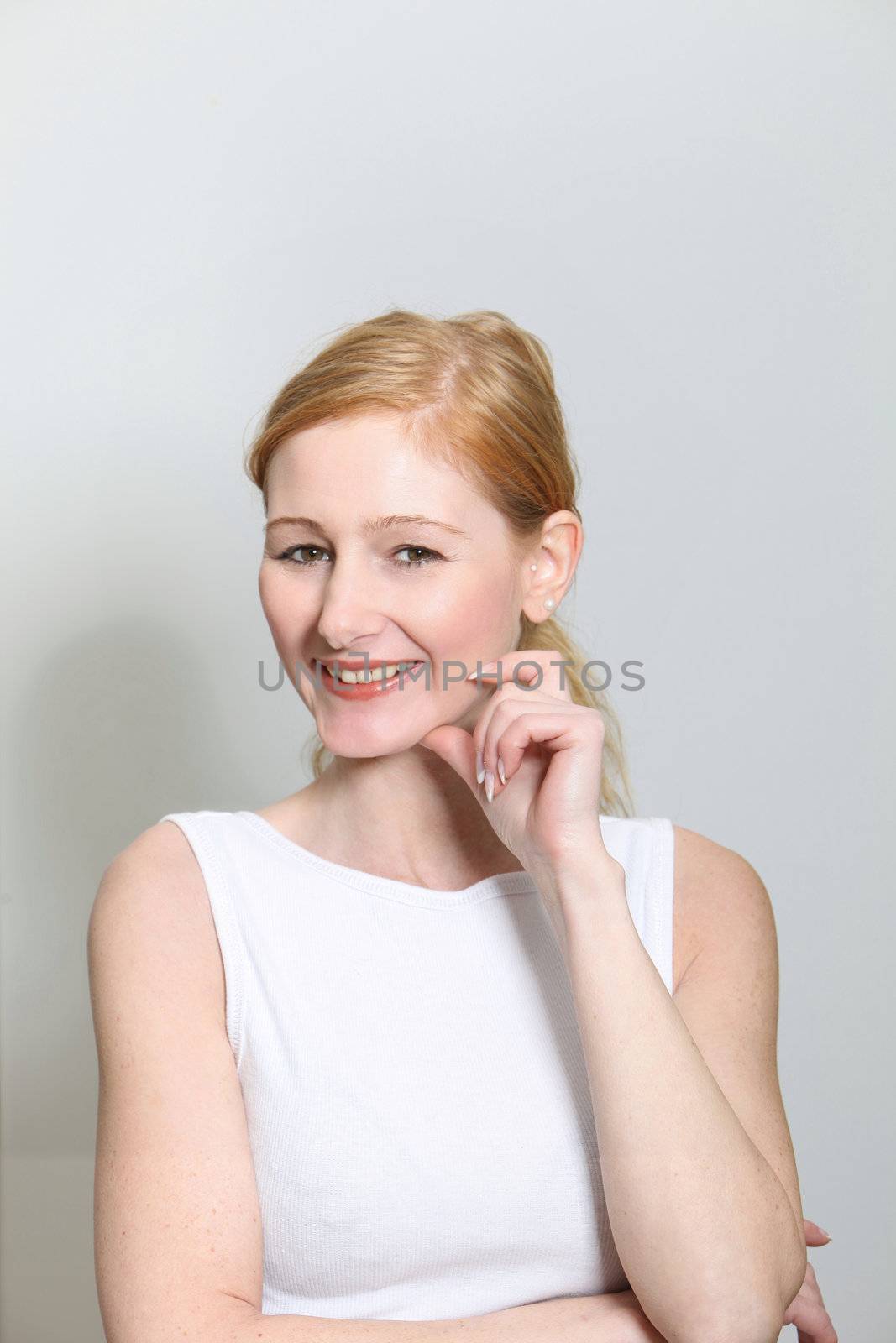 Portait of a young, cheerful woman - portrait format
