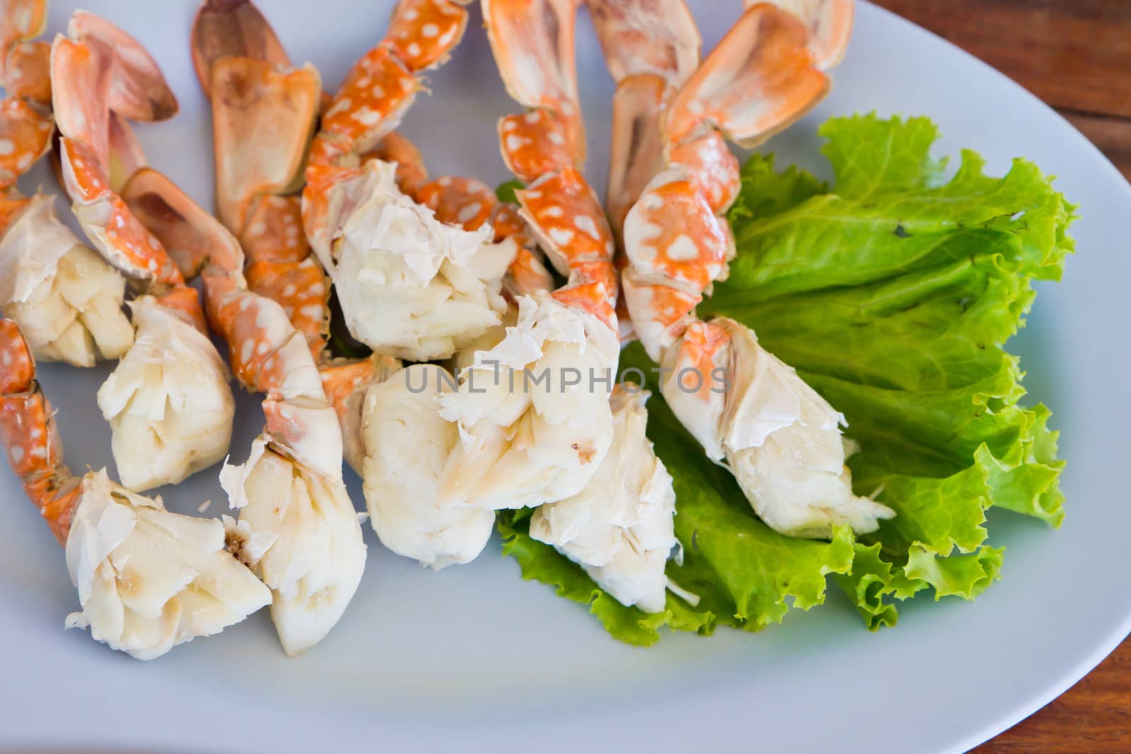 Piles of crab legs on a plate.