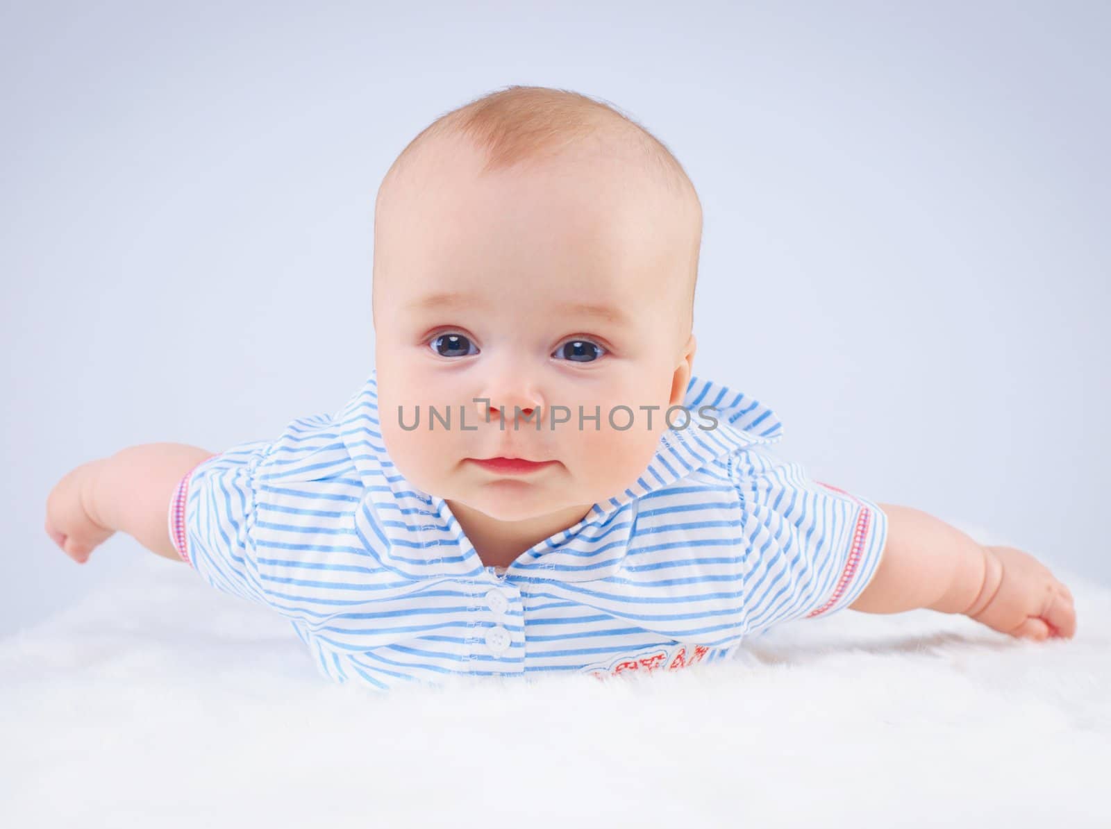 Clouse-up portrait pretty little girl in blue. In studio