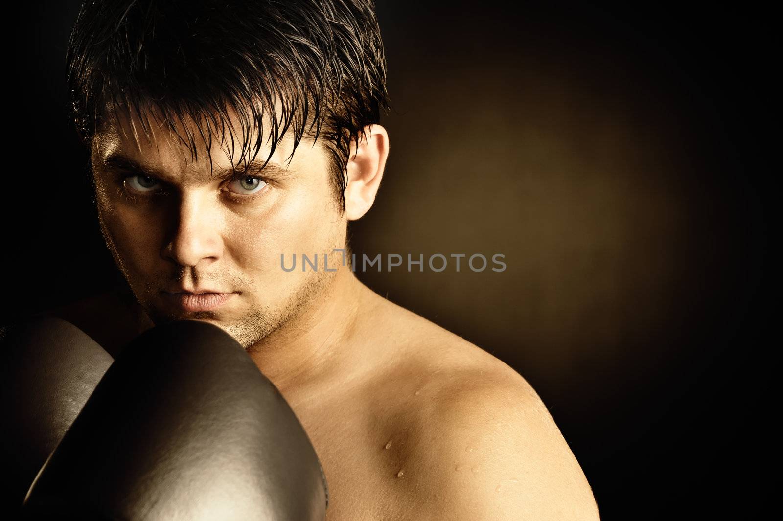 The boxer. The young man in boxing gloves